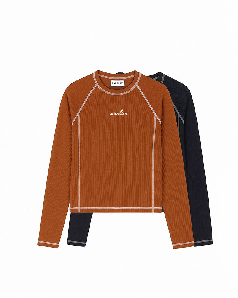 Two long-sleeve shirts, one brown and one navy, on a white background.