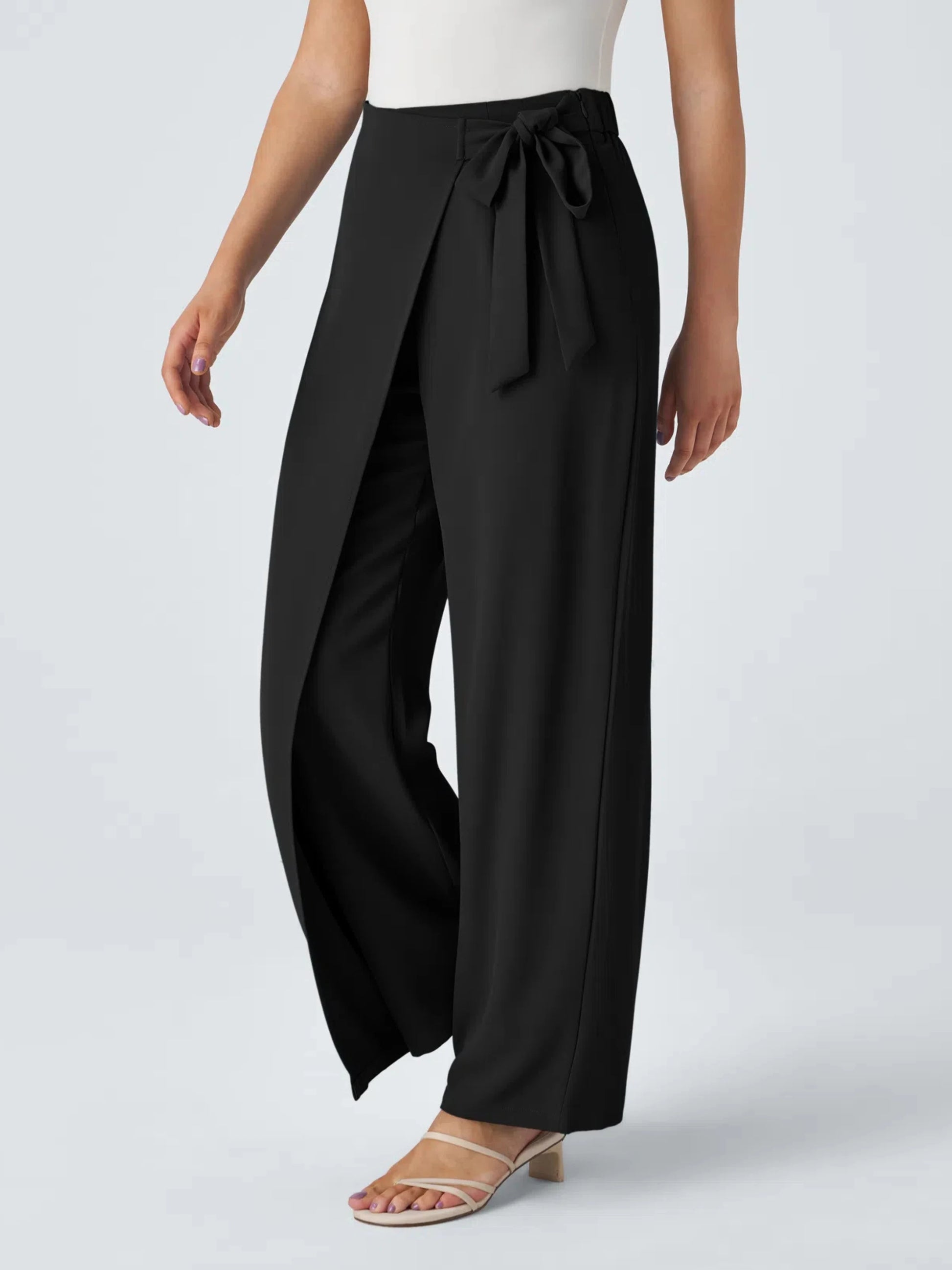 Black wide-leg pants with a tie waist worn by a person on a white background