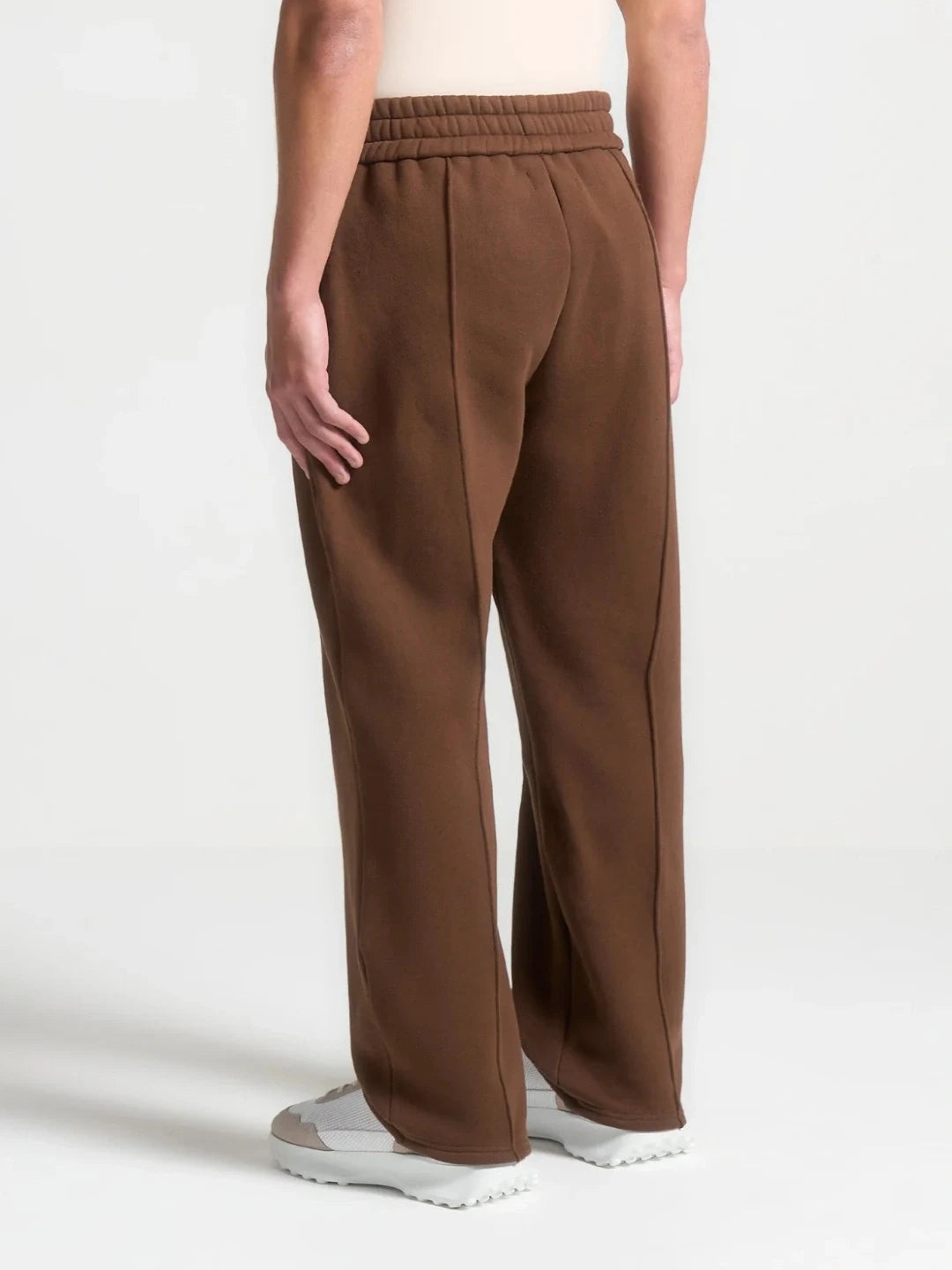 Brown wide-leg pants worn by a person on a white background