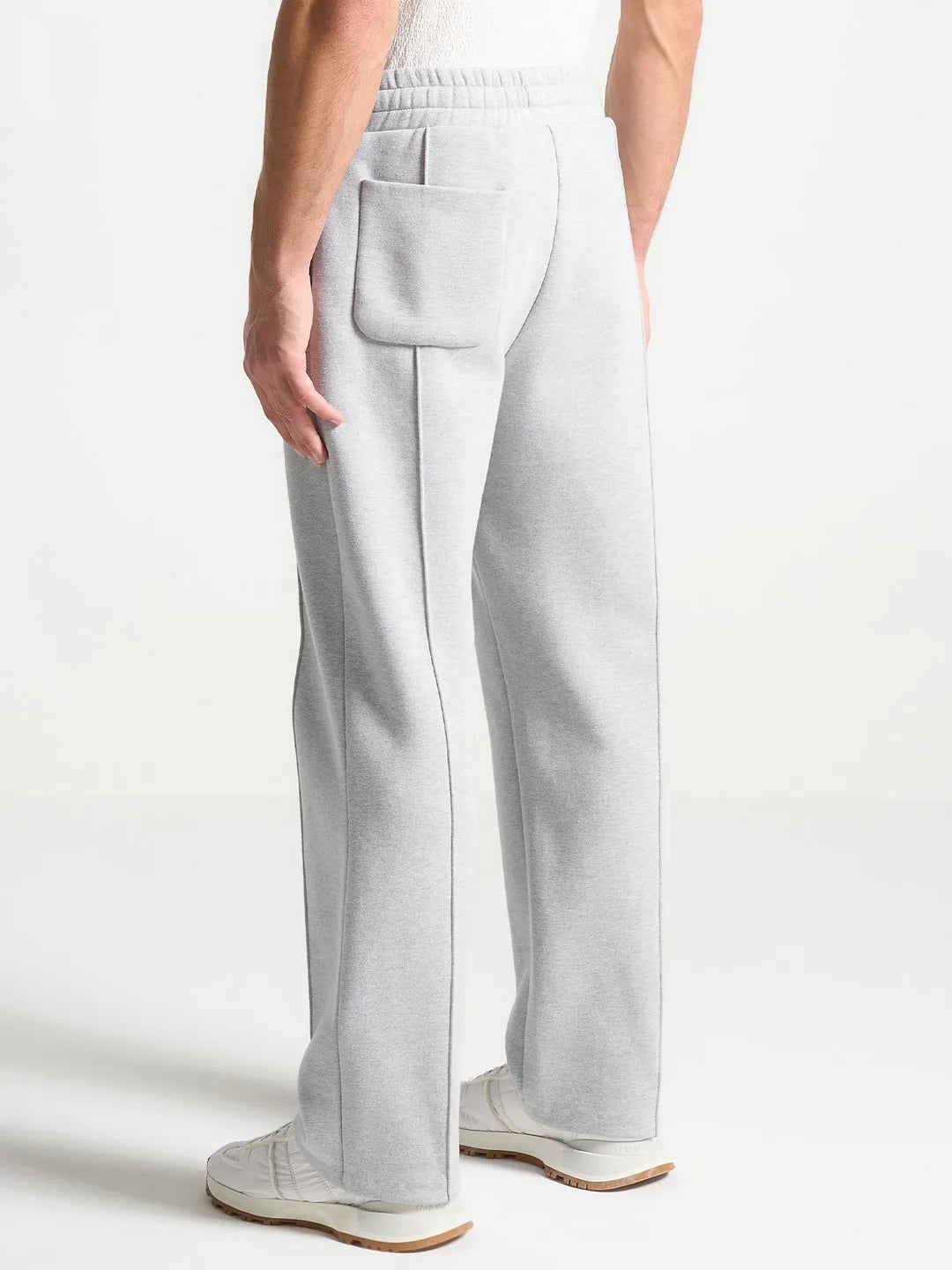 Light gray pants worn by a person on a white background