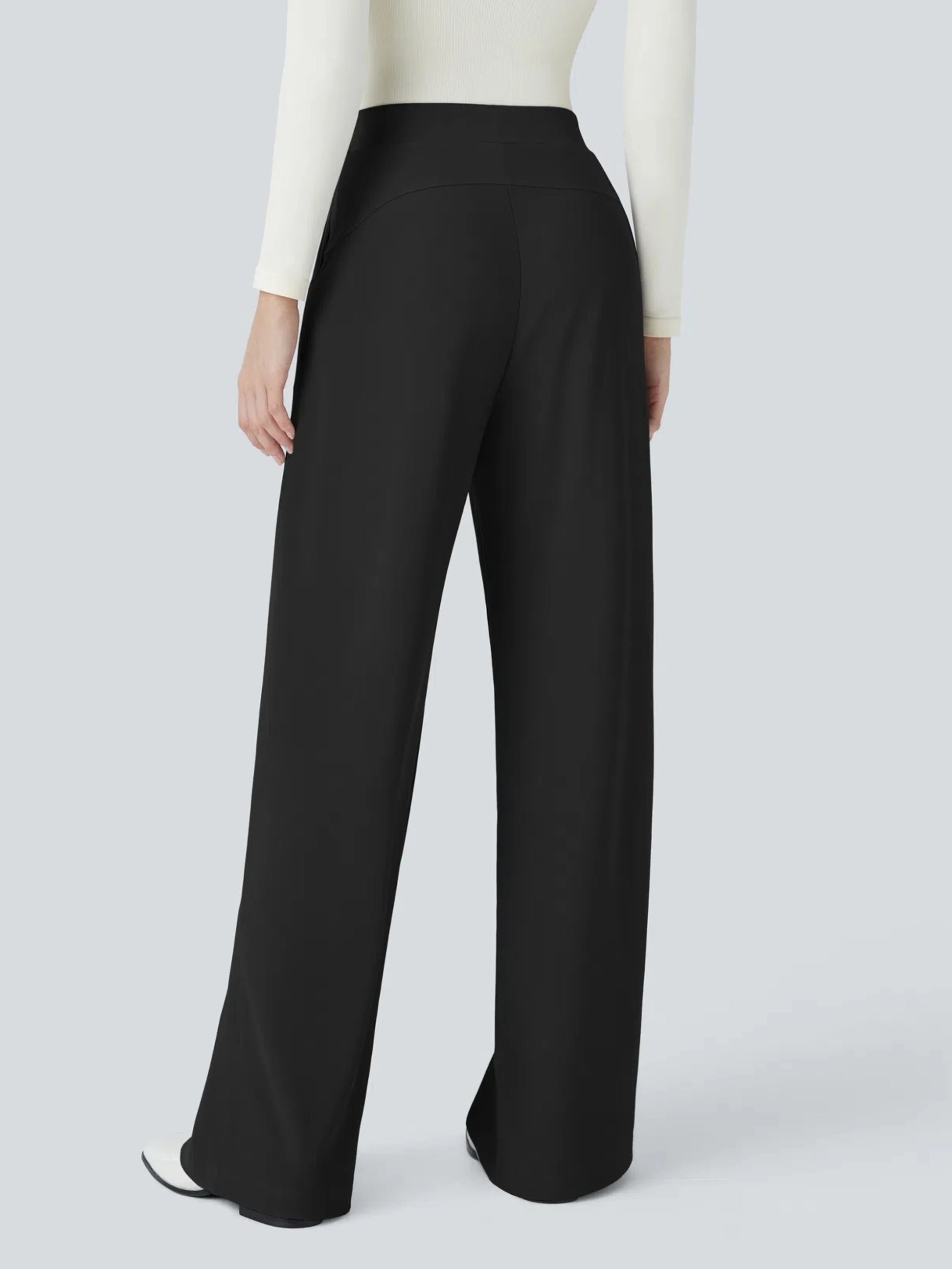 Black wide-leg pants worn by a person on a light gray background