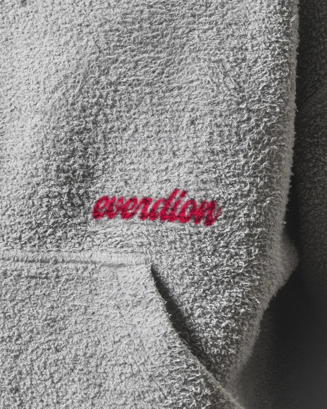 Gray fleece fabric with 'everdion' embroidery in red.