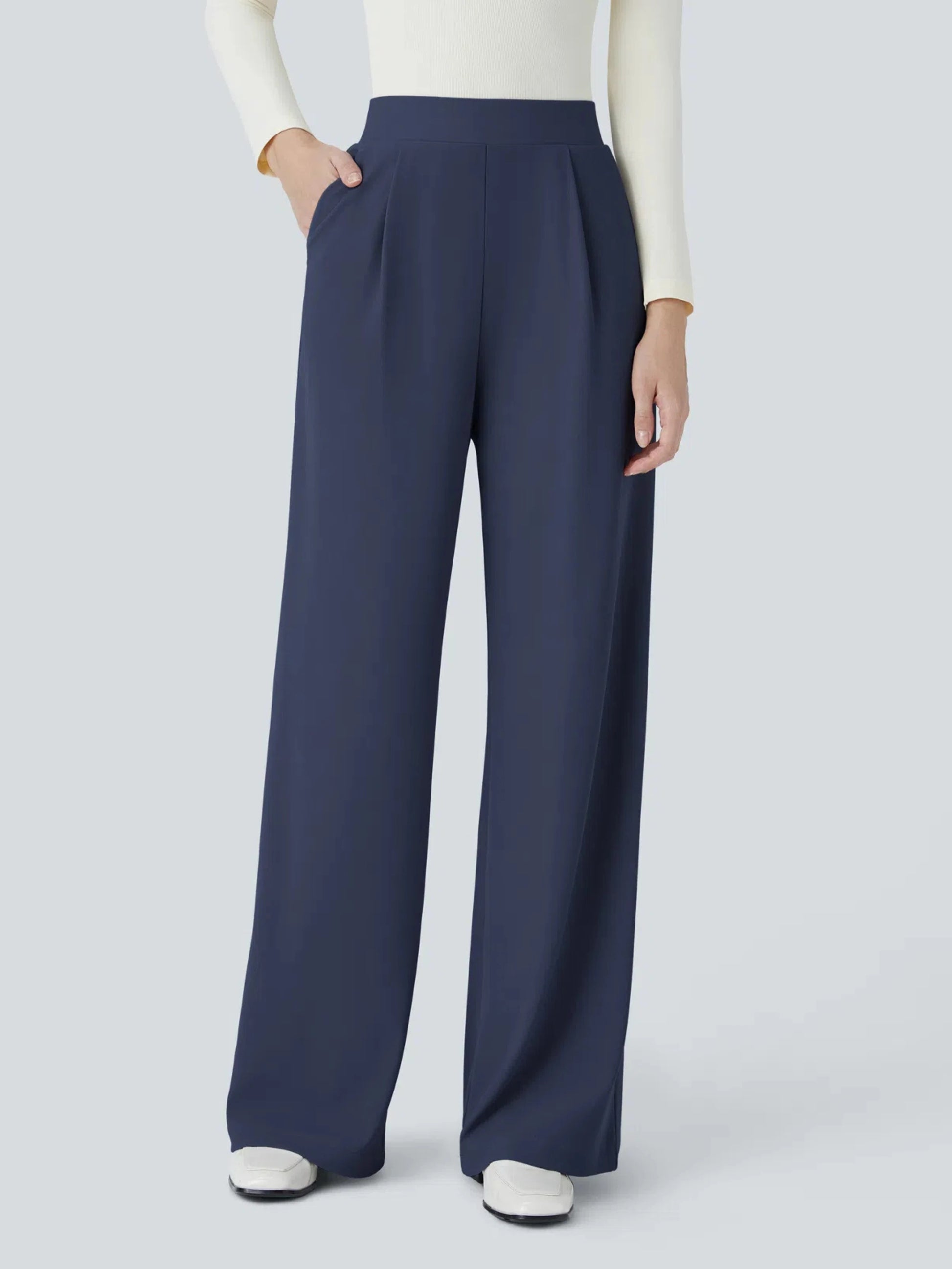 Navy wide-leg pants worn by a person on a light gray background