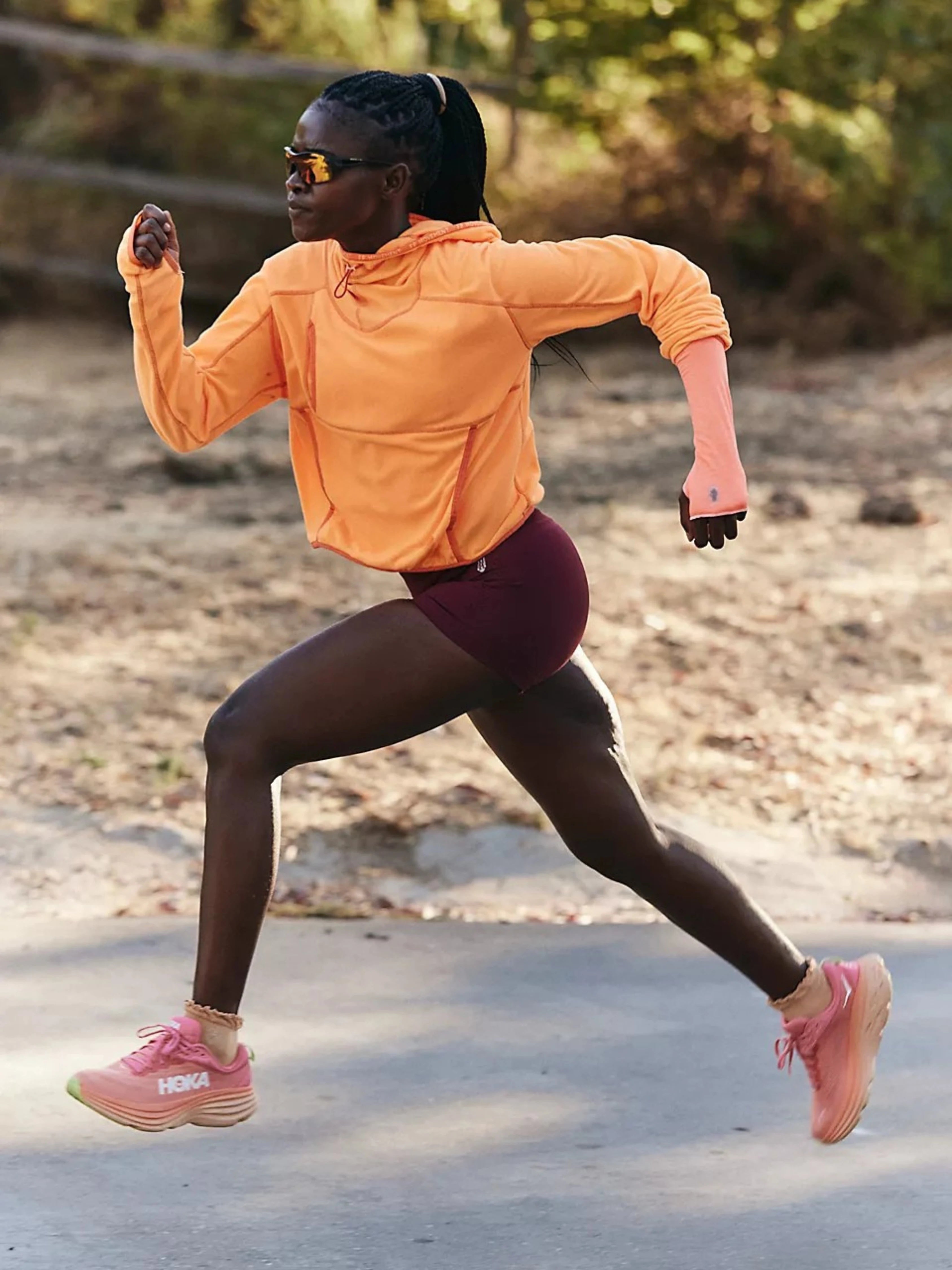 Woman running outdoors on a path with trees in the background