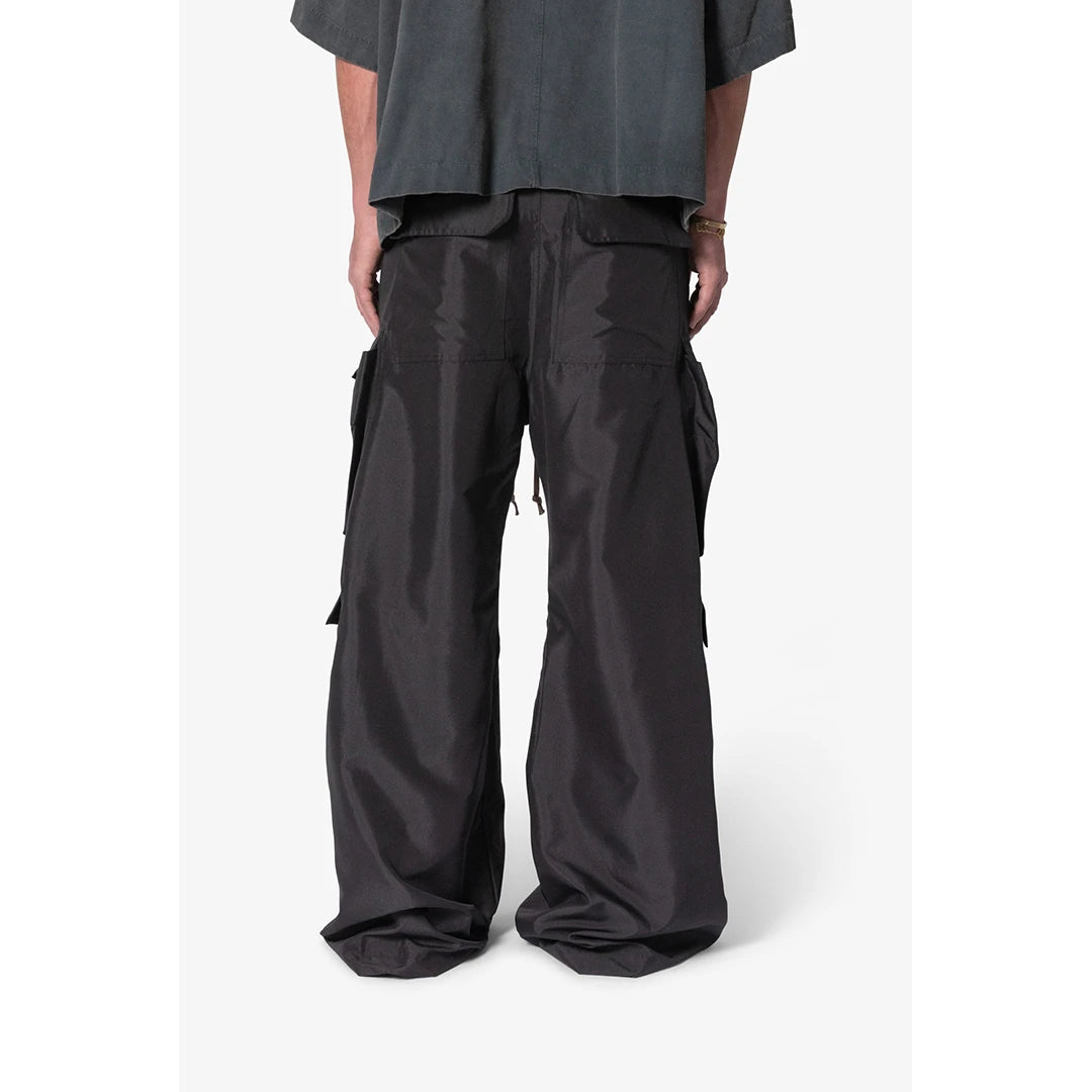 Person wearing black cargo pants on a white background