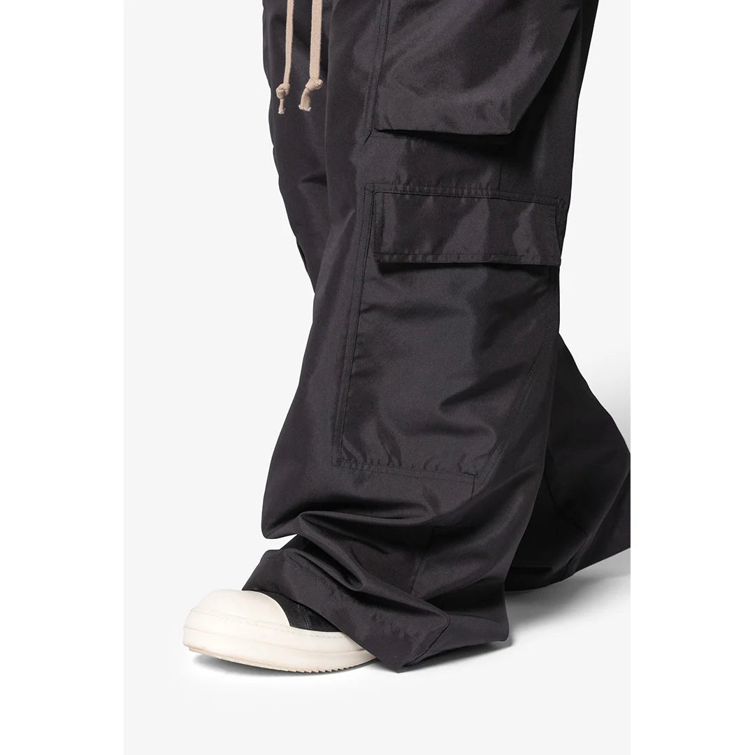 Black cargo pants worn by a person on a white background