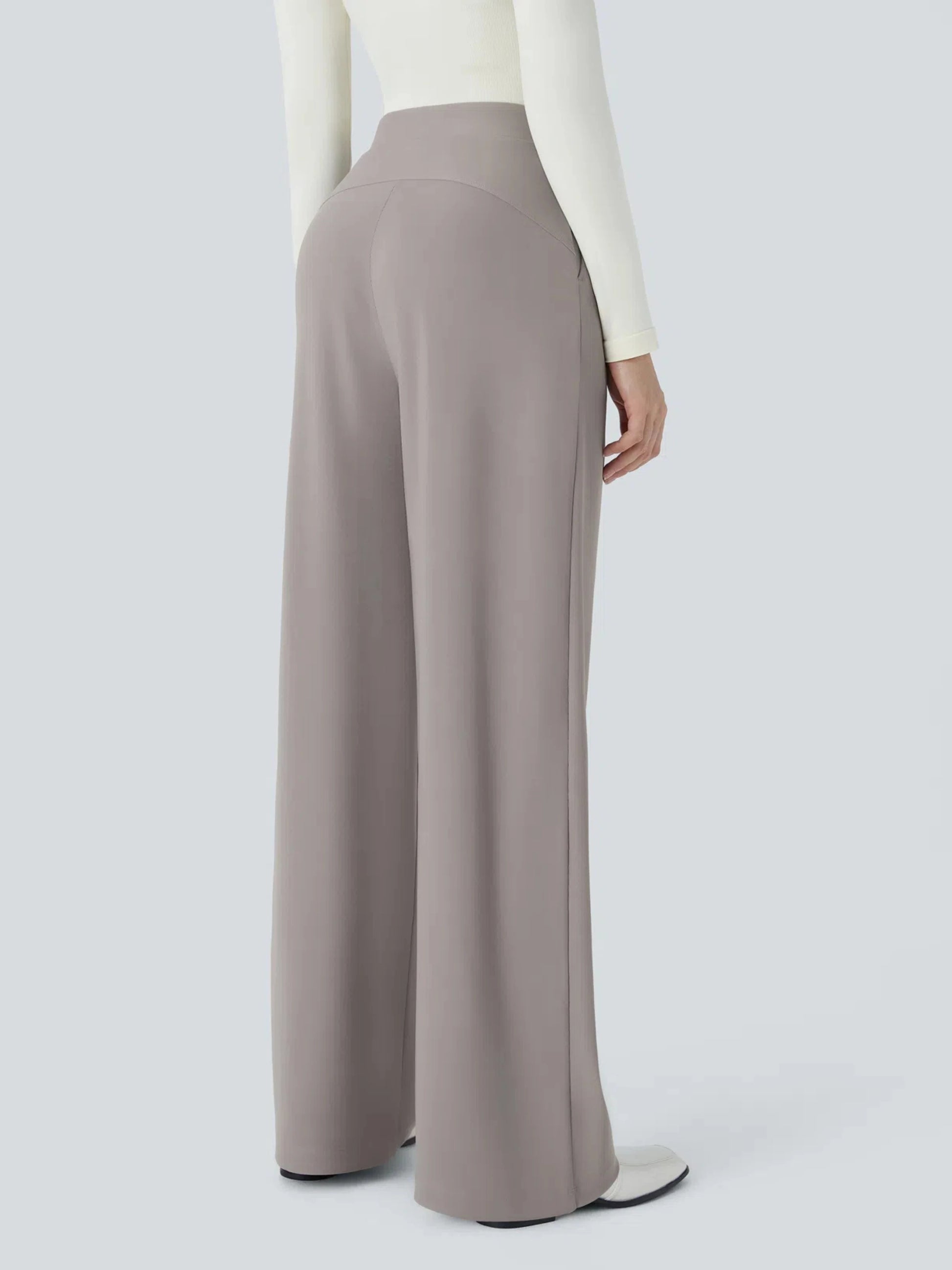Person wearing light gray wide-leg pants on a plain background