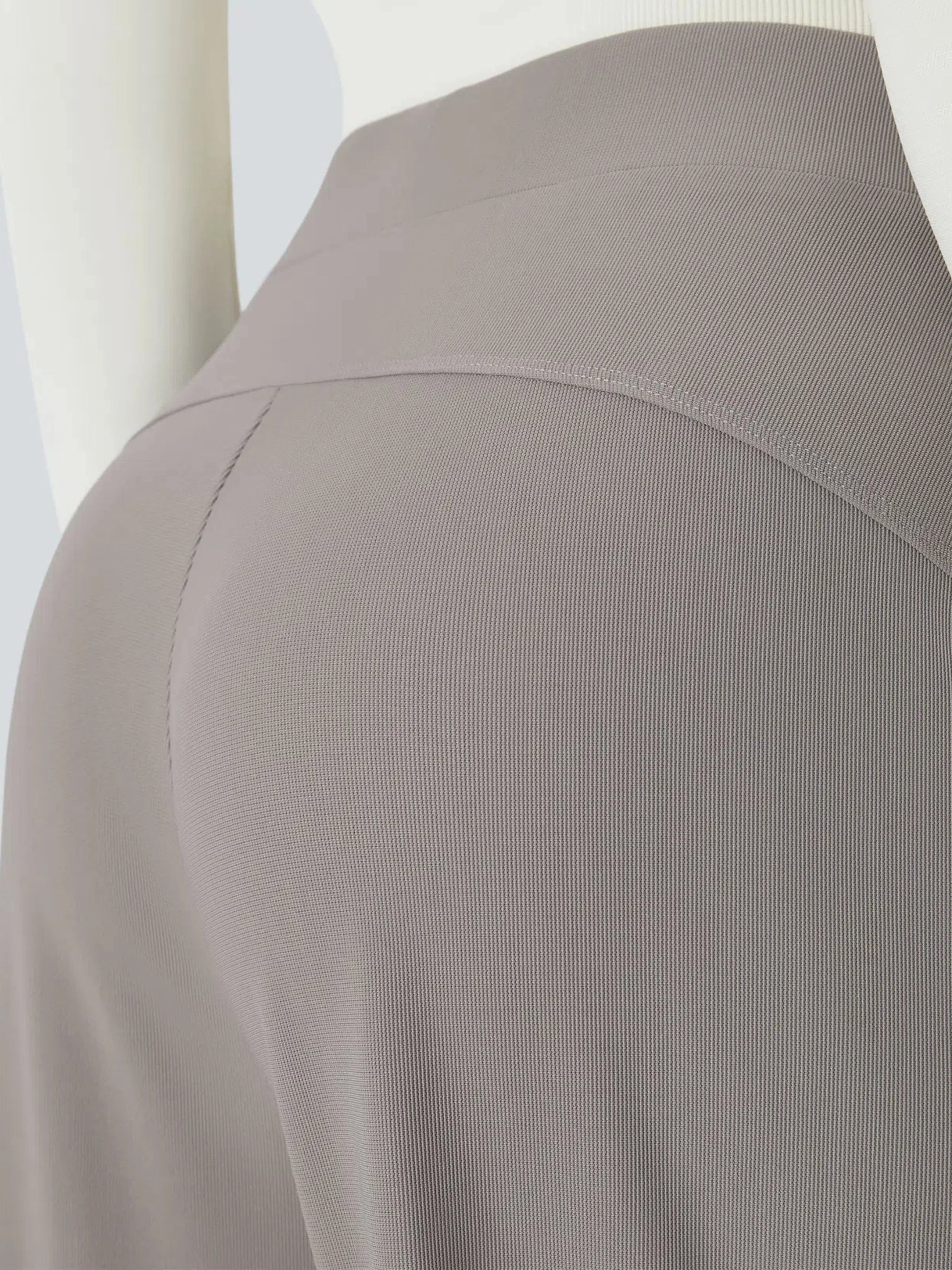 Close-up of a gray ribbed knit garment on a mannequin