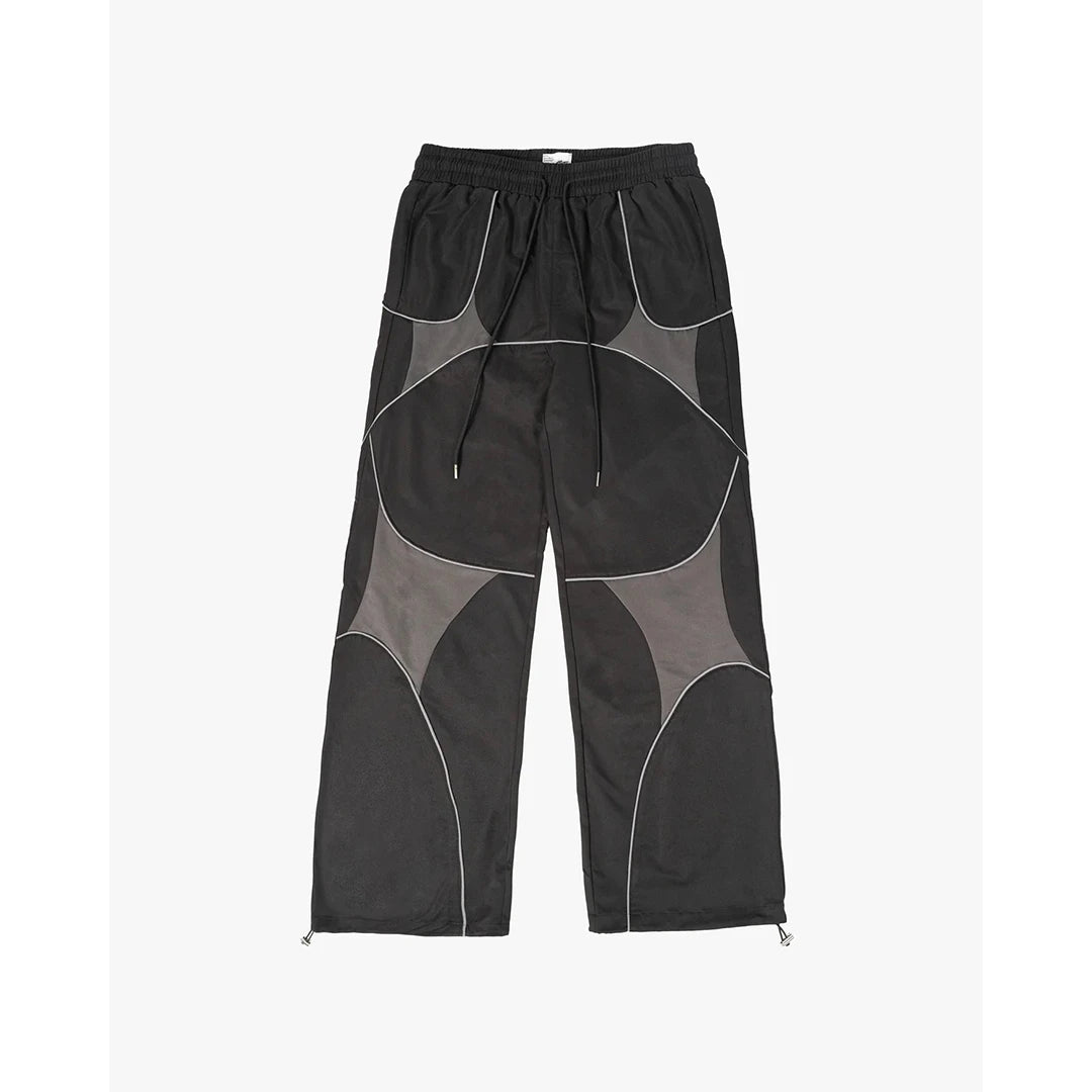 Black pants with geometric gray patches on a white background