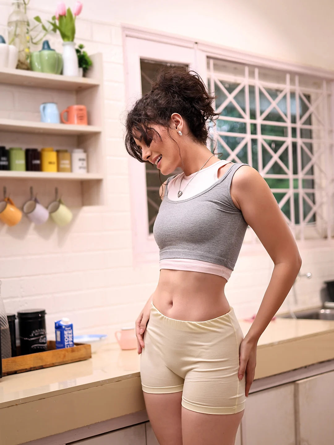 Woman in athletic wear standing in a kitchen