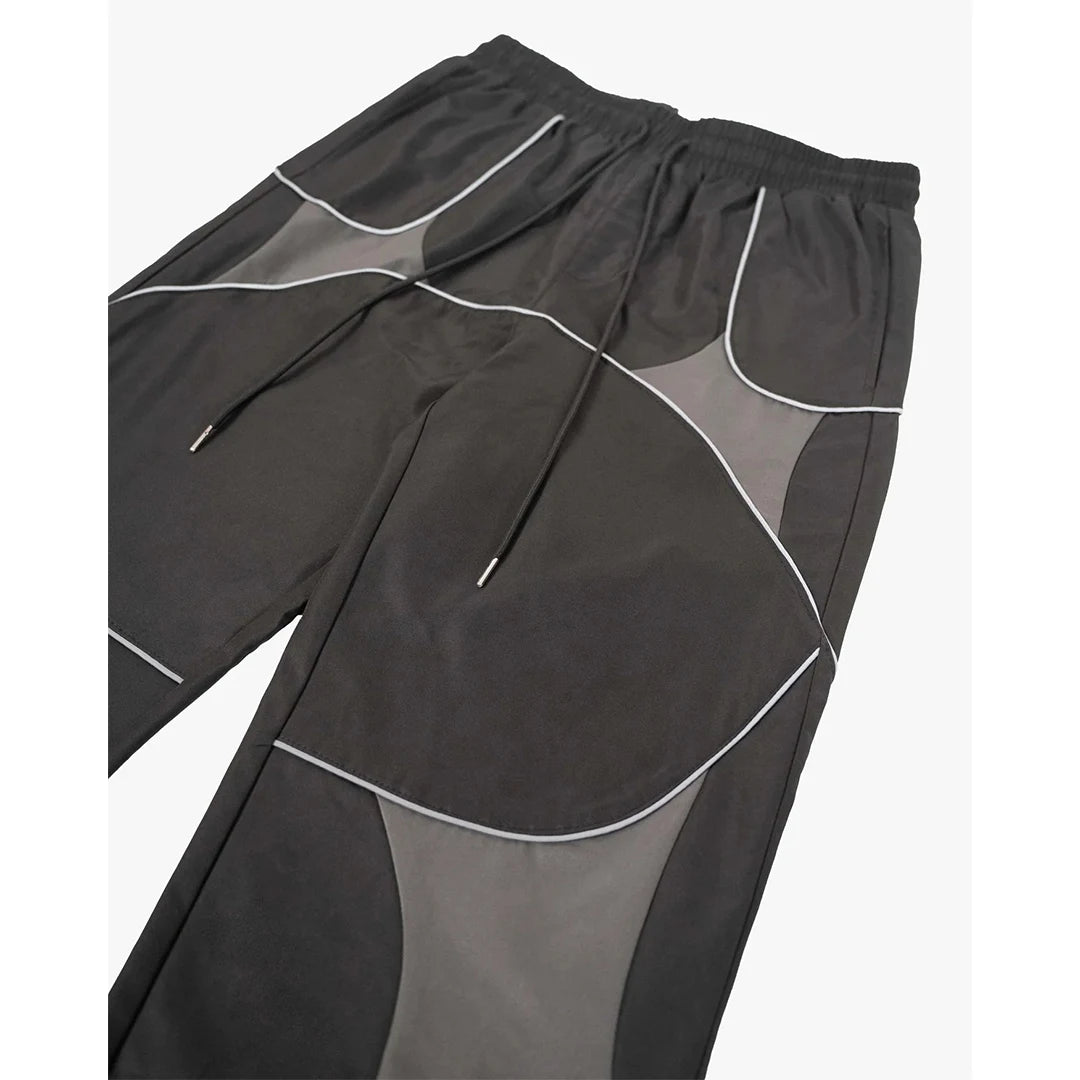 Black and gray athletic pants with white accents on a white background