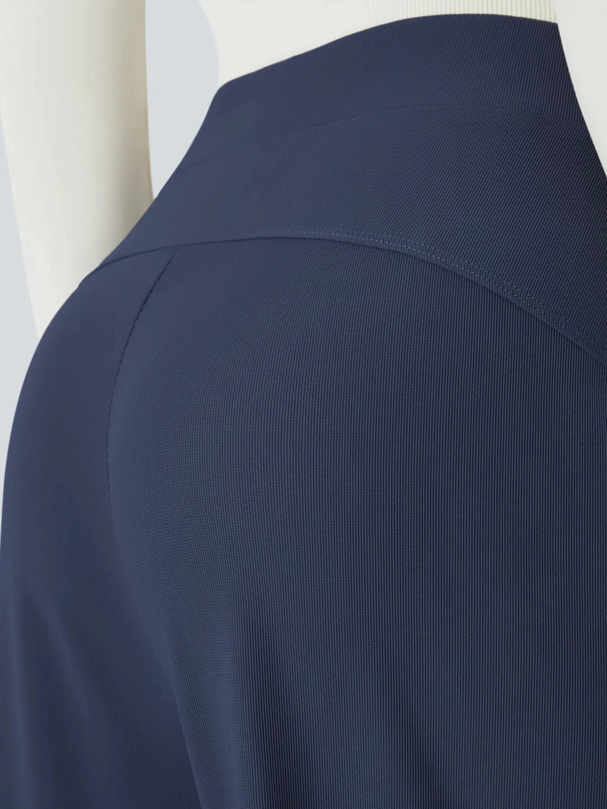 Navy blue shirt on a mannequin with a plain background