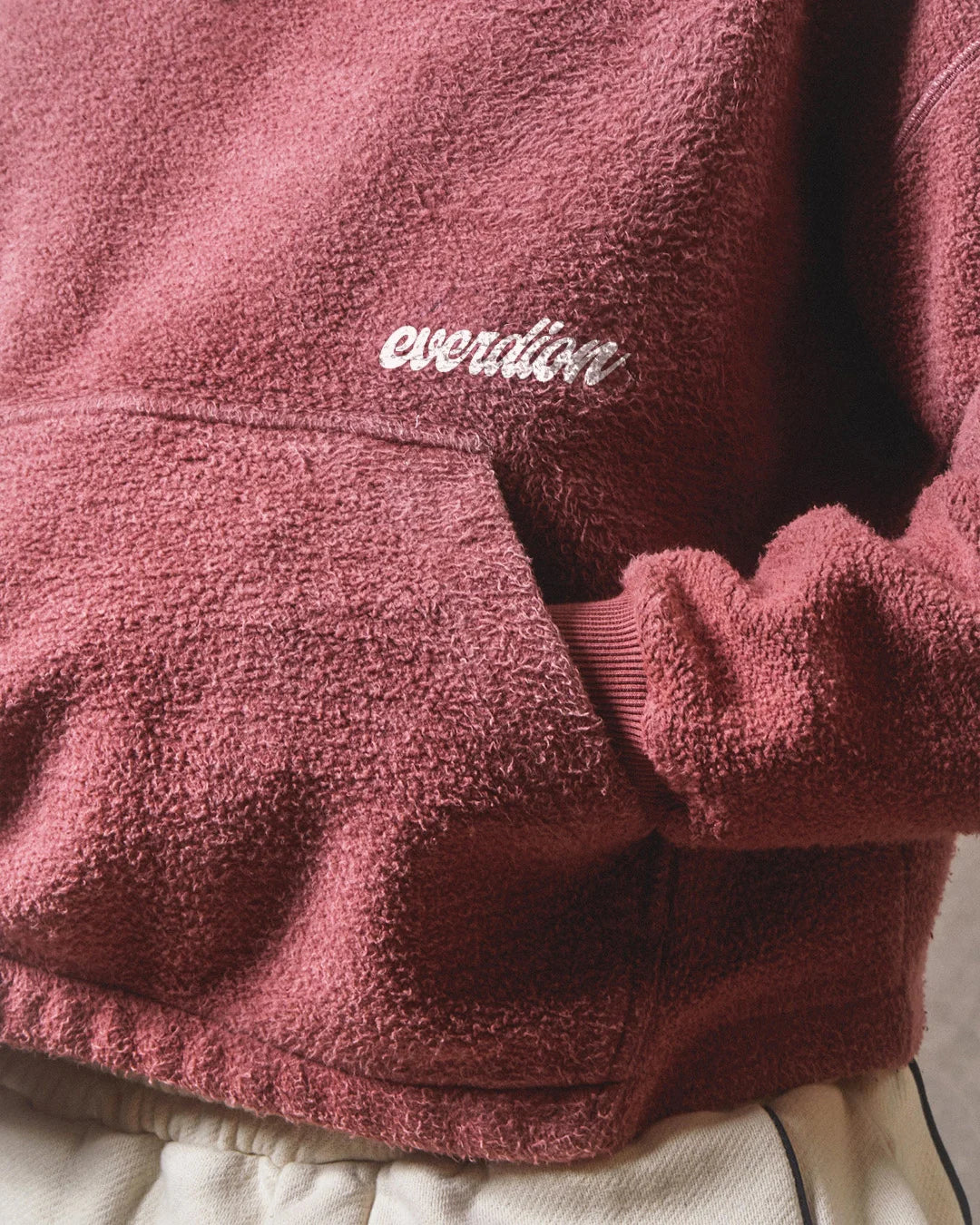Close-up of a burgundy fleece jacket with 'Everdion' branding.