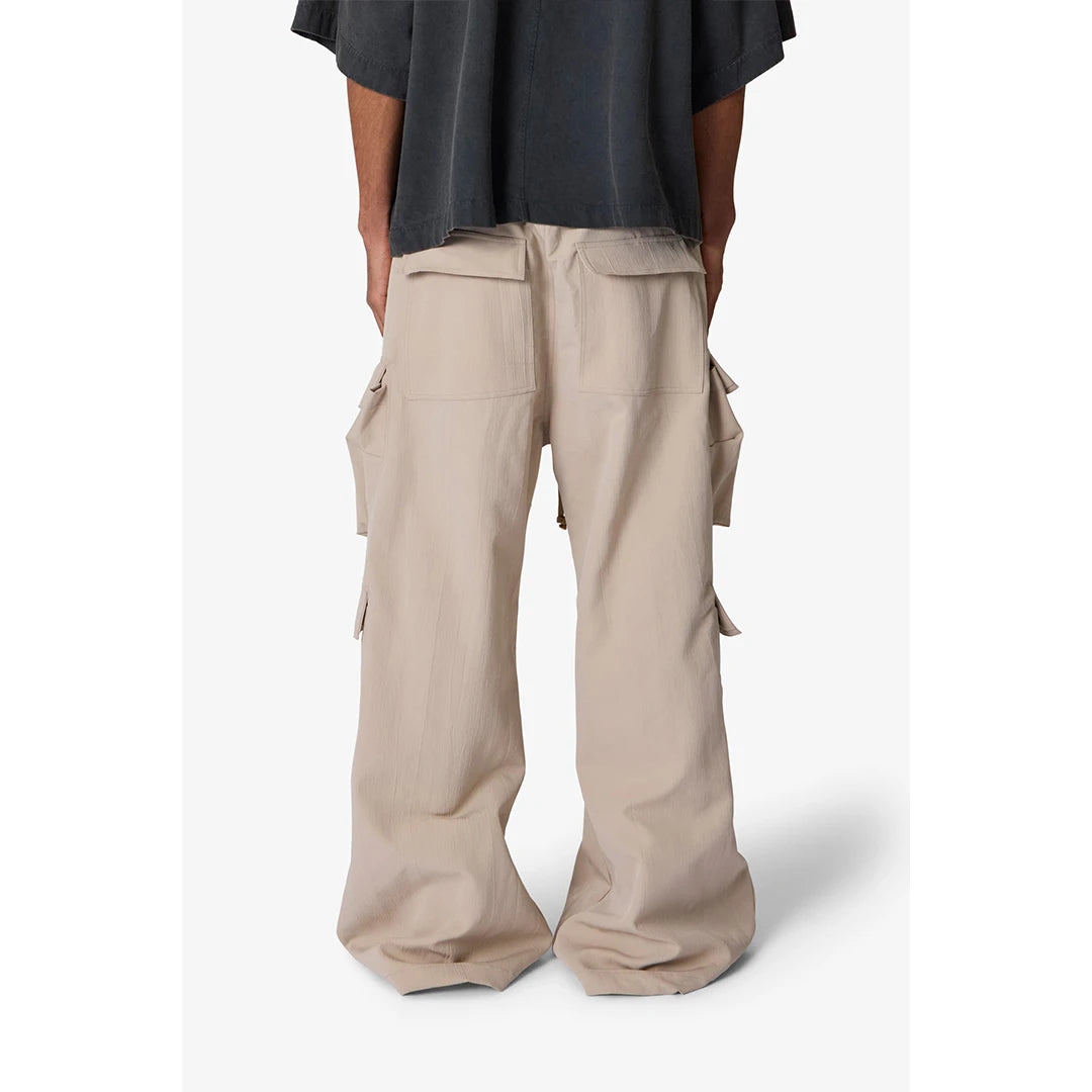 Beige cargo pants worn by a person on a white background