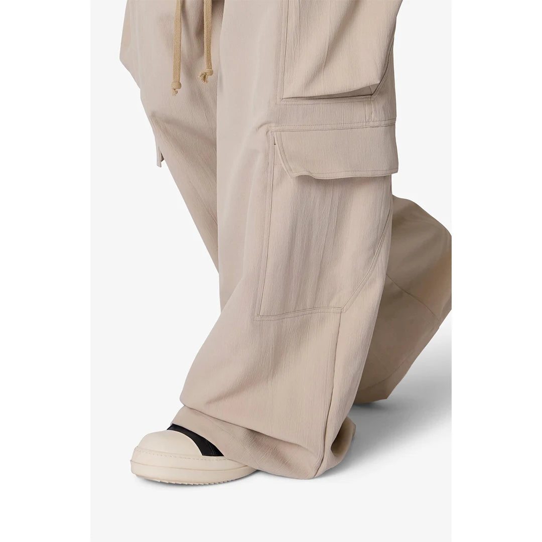 Beige cargo pants worn by a person on a white background
