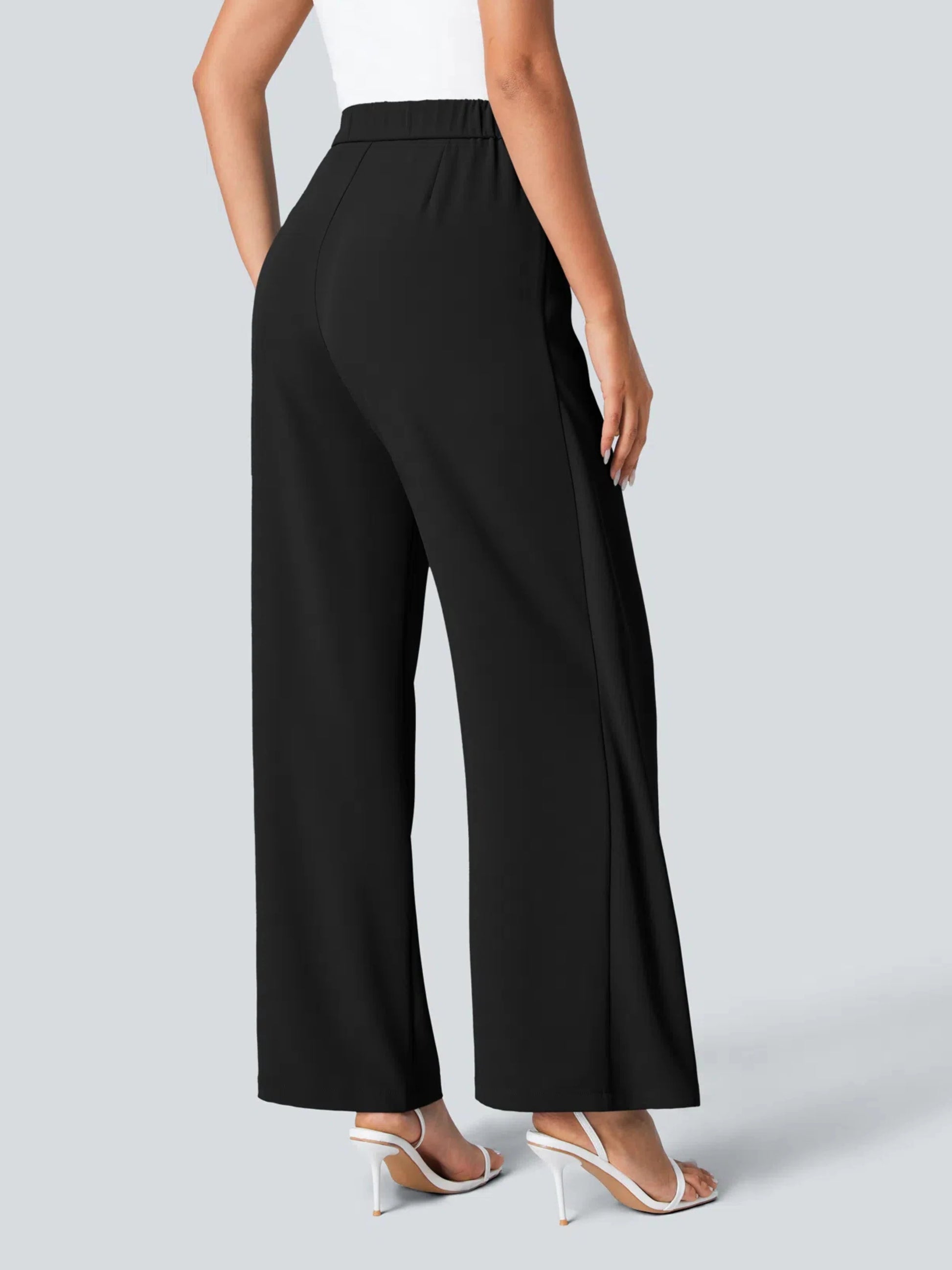 Black wide-leg pants worn by a person on a light gray background