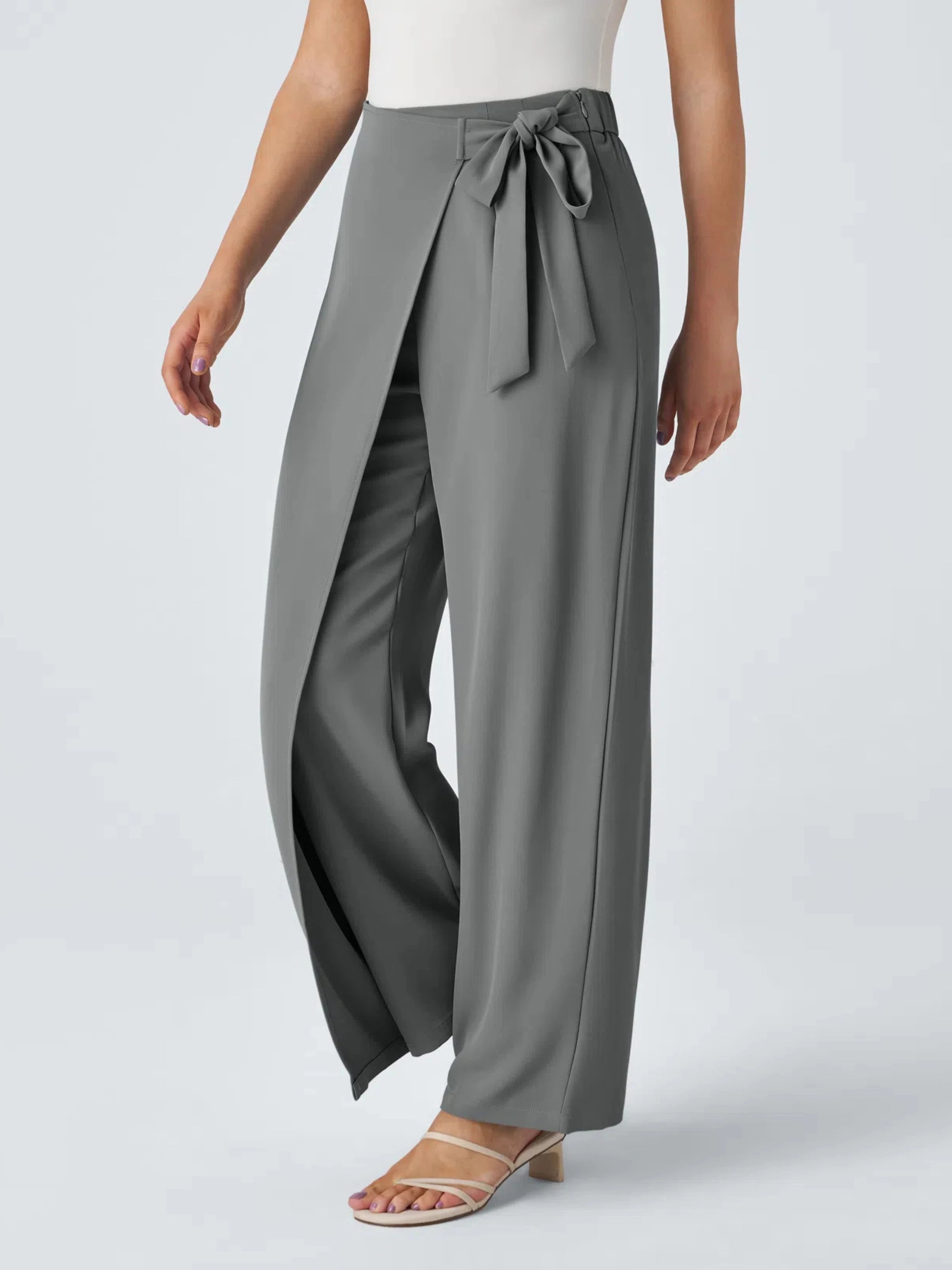 Gray wide-leg pants with a tie waist worn by a person on a light gray background