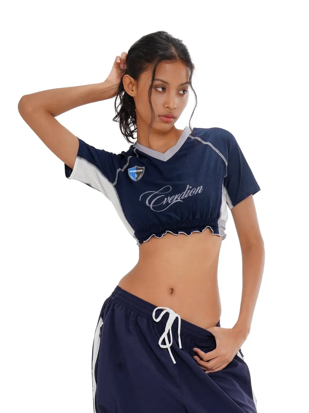 Woman wearing a navy sports outfit with 'Everdion' branding on a white background