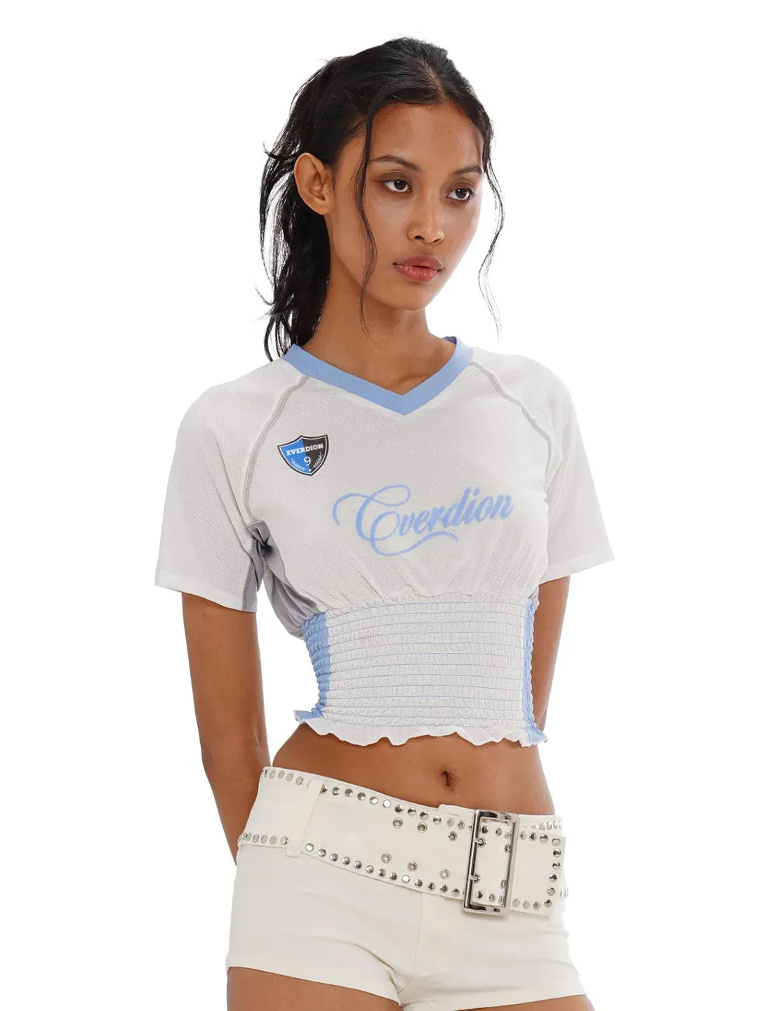 Woman wearing a white and blue sports outfit with 'Everdion' branding on a white background