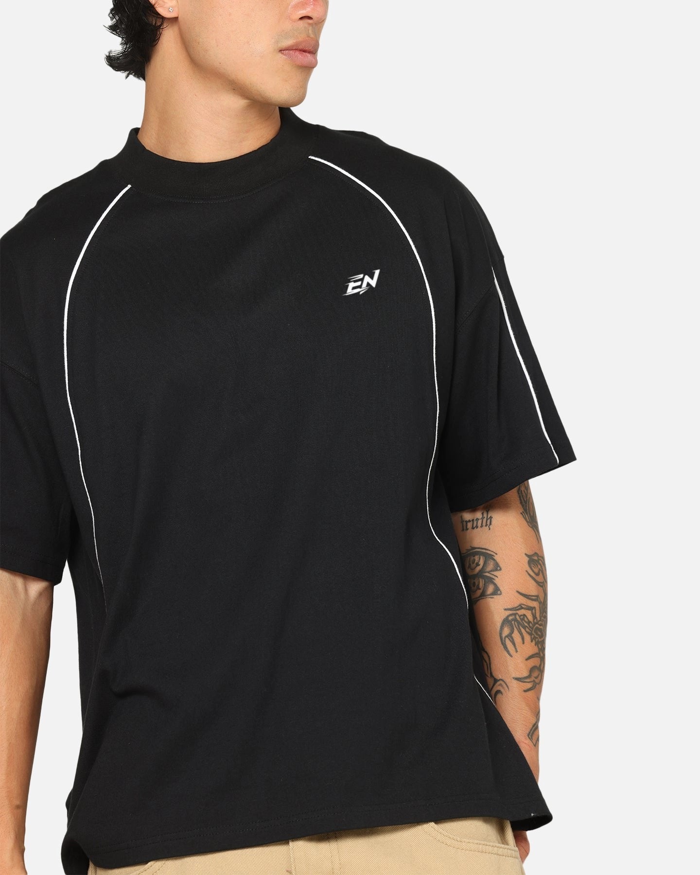 Person wearing a black athletic shirt with a logo on a white background