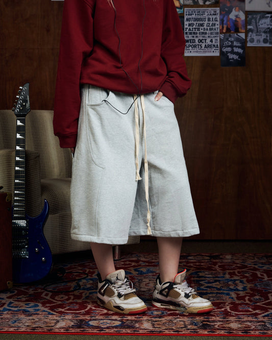 Oversized grey carpenter shorts with elastic drawstring waist and wide-leg fit