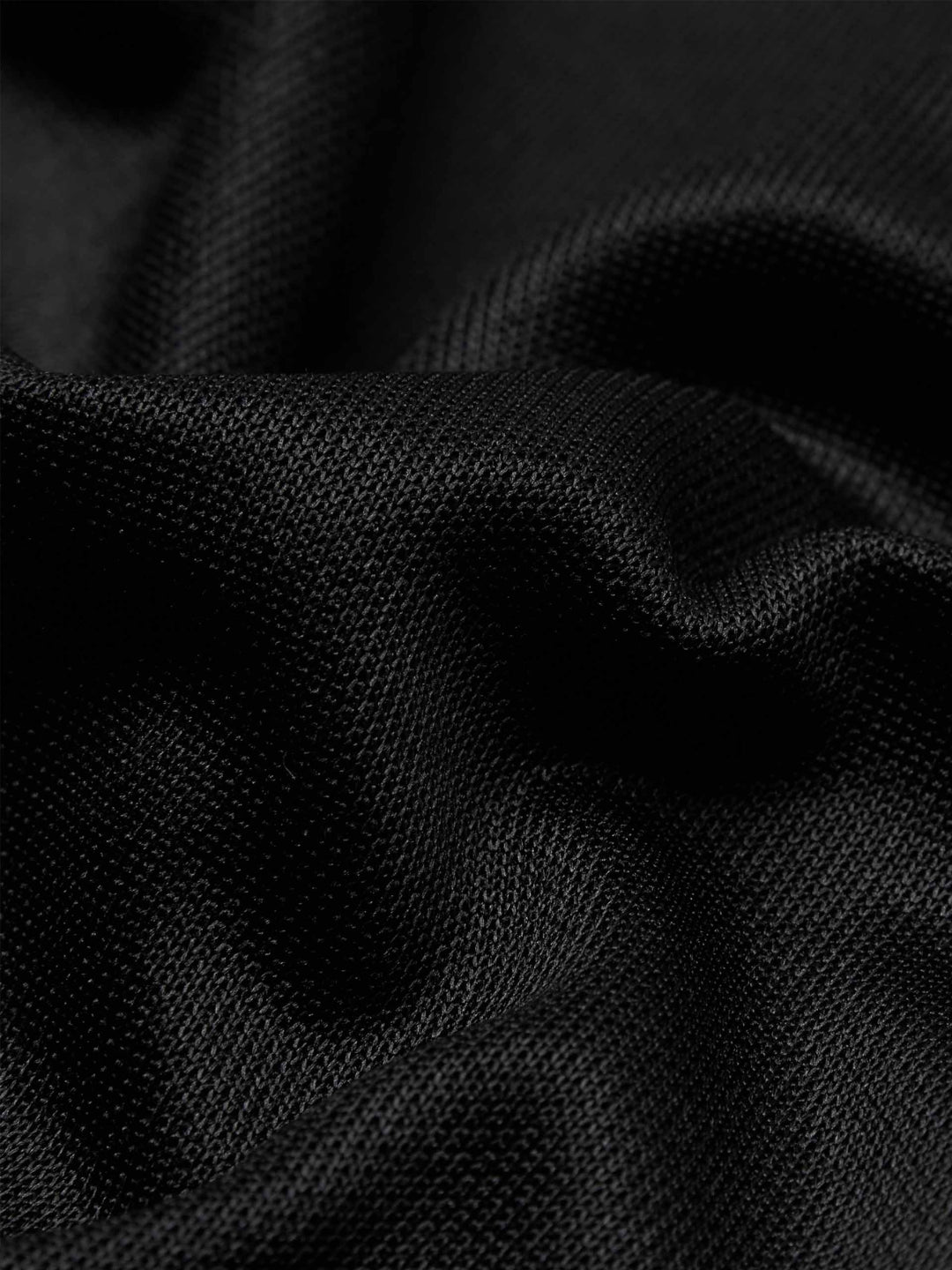 black slit snap button tracks pants with an elastic drawstring waist, featuring white stripes on the legs and a side slit on one leg