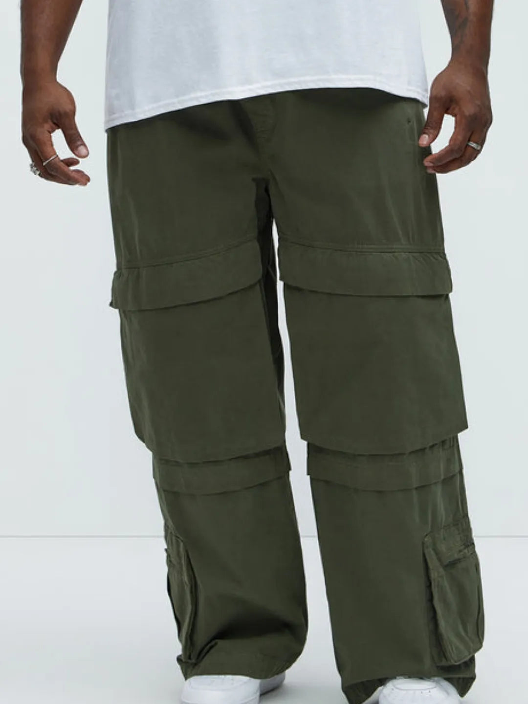 Person wearing a white t-shirt and Green cargo pants on a white background