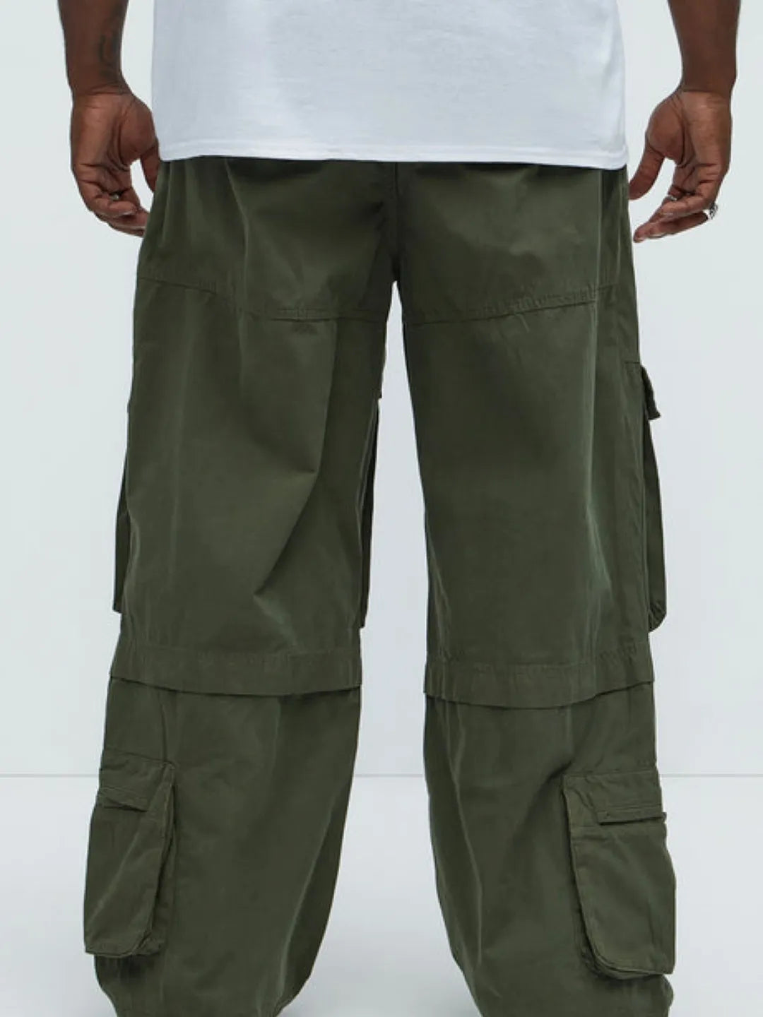 Person wearing a white t-shirt and Green cargo pants on a white background