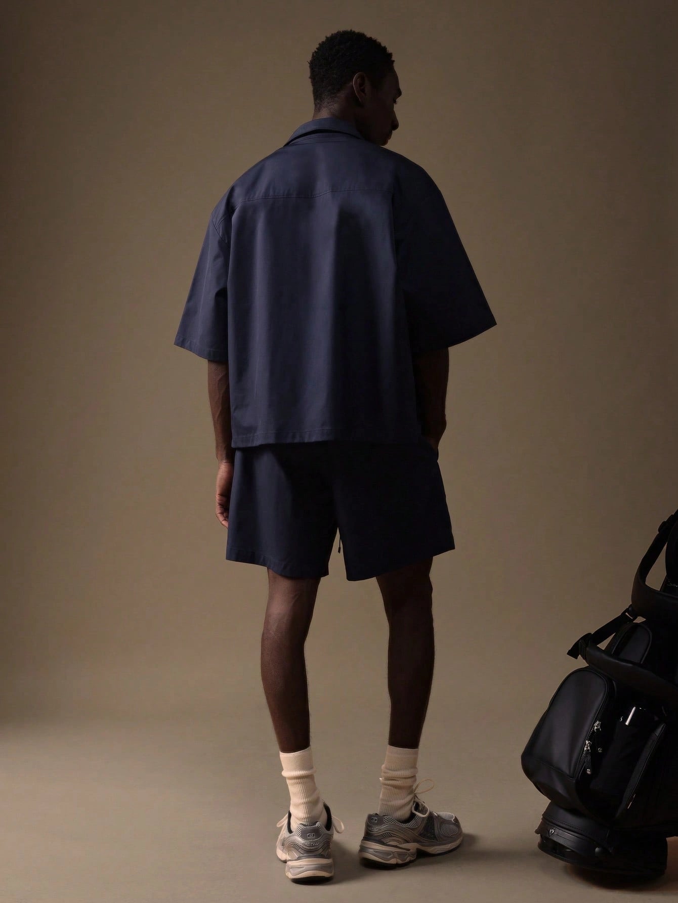 Model wearing the Auba Short Sleeve Shirt and Shorts Set in navy, matching outfit set