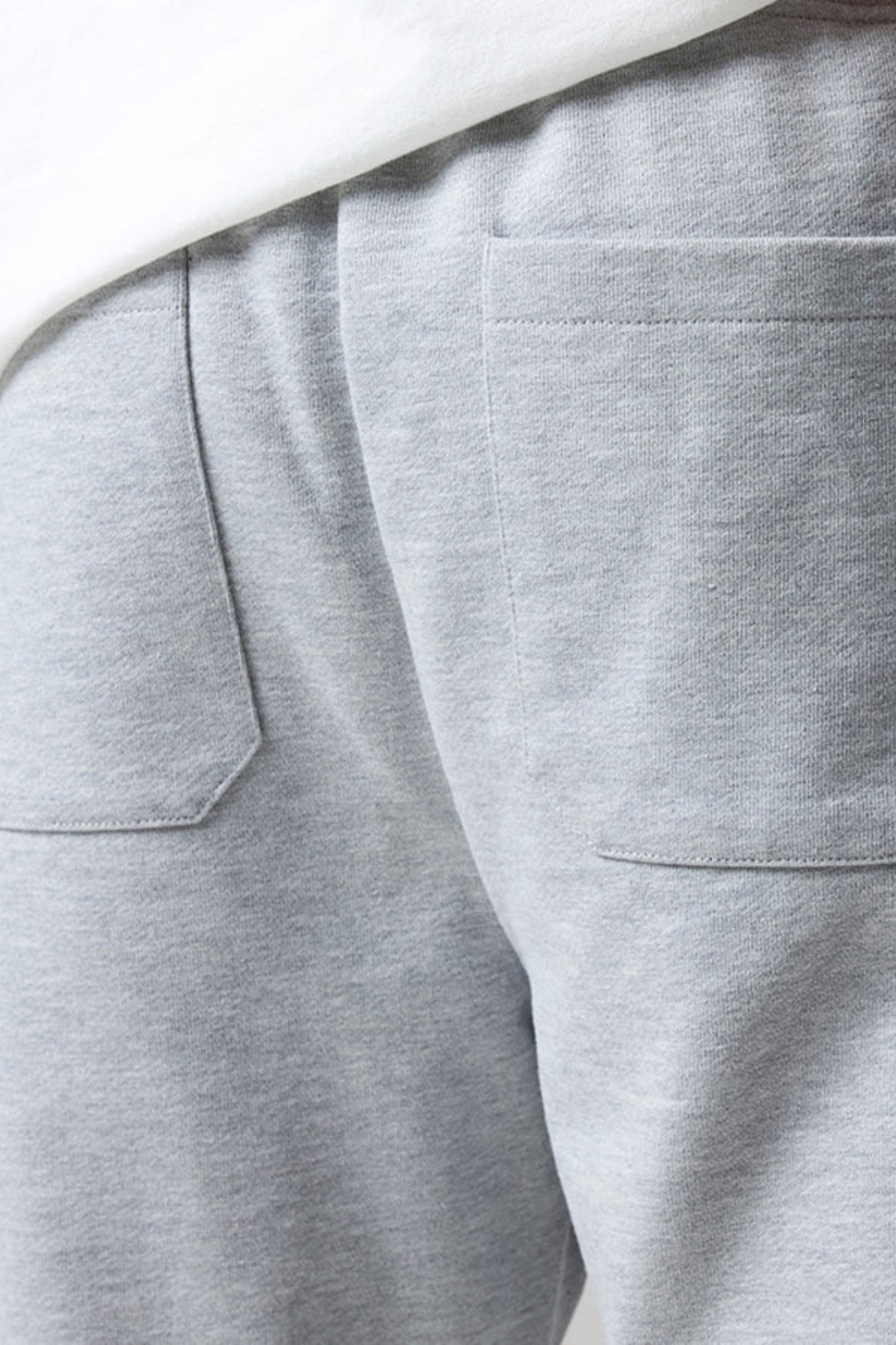 wearing grey open hem joggers with an elastic waistband and drawstring with back pockets