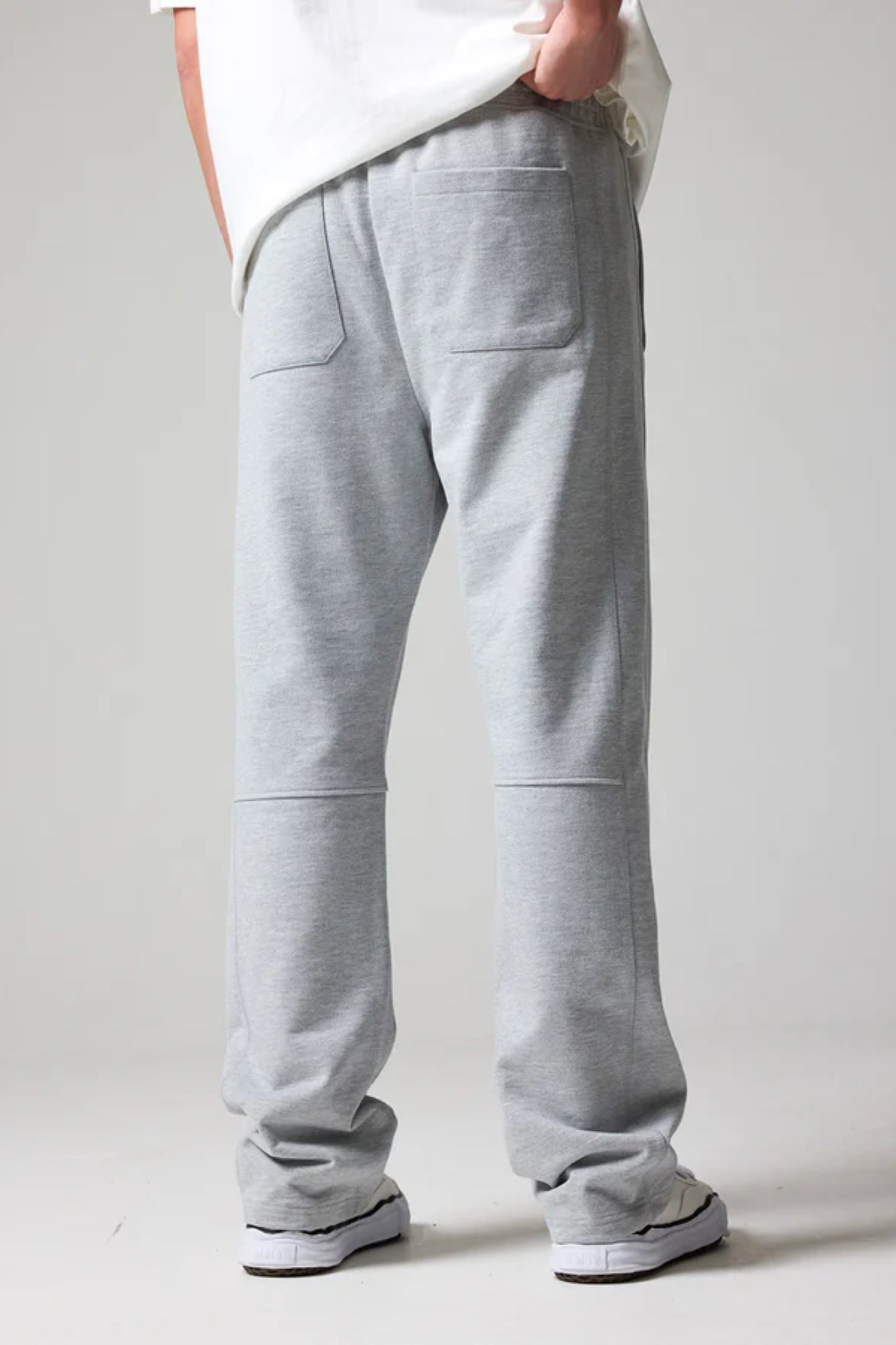 A pair of gray open hem jogger pants with an elastic waistband and drawstring, featuring side pockets.