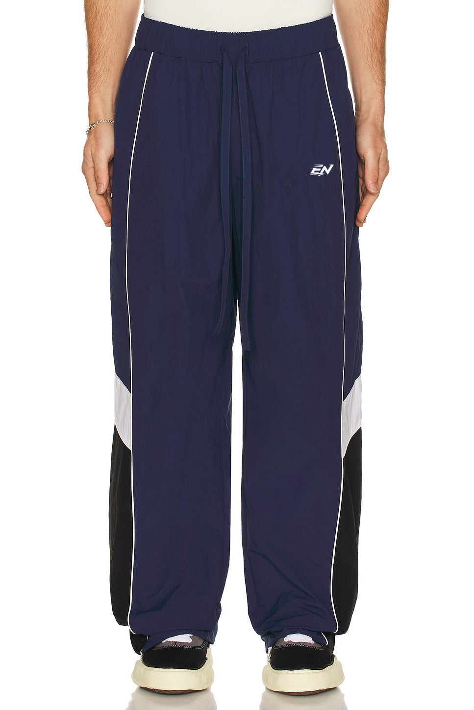 Navy blue pants with white and black accents on a white background