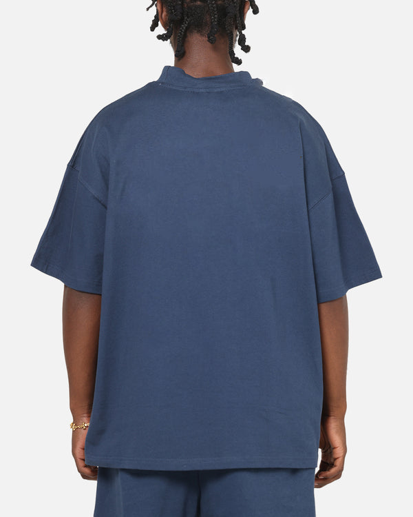 Person wearing a blue oversized t-shirt on a plain background