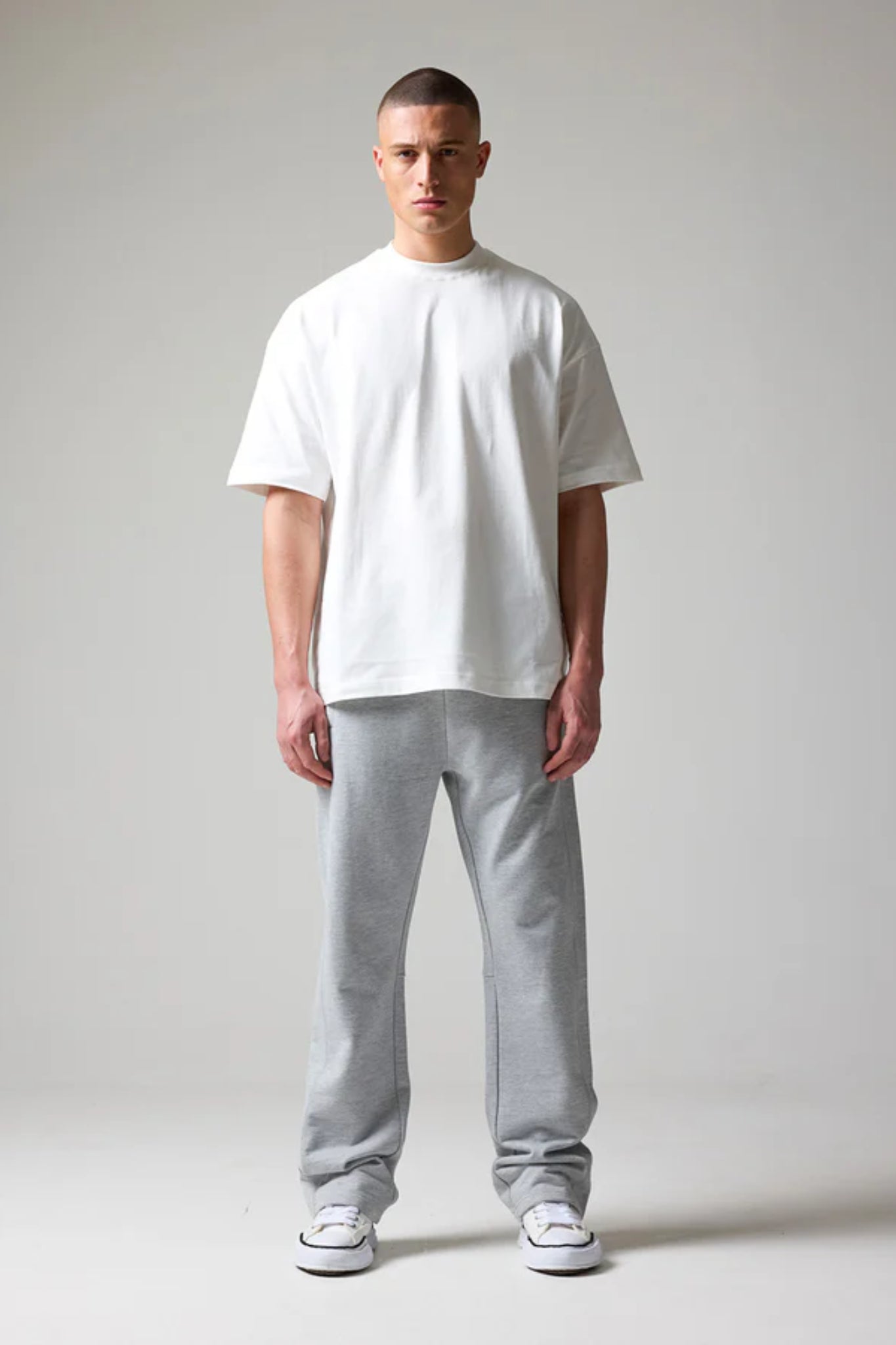 wearing grey open hem joggers with an elastic waistband and drawstring 