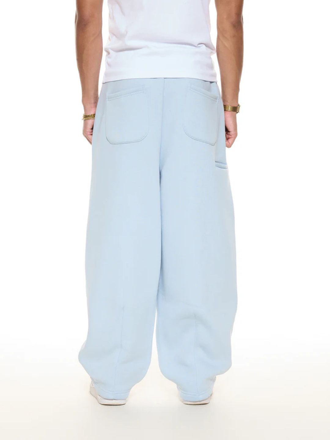 Light blue pants worn by a person on a white background
