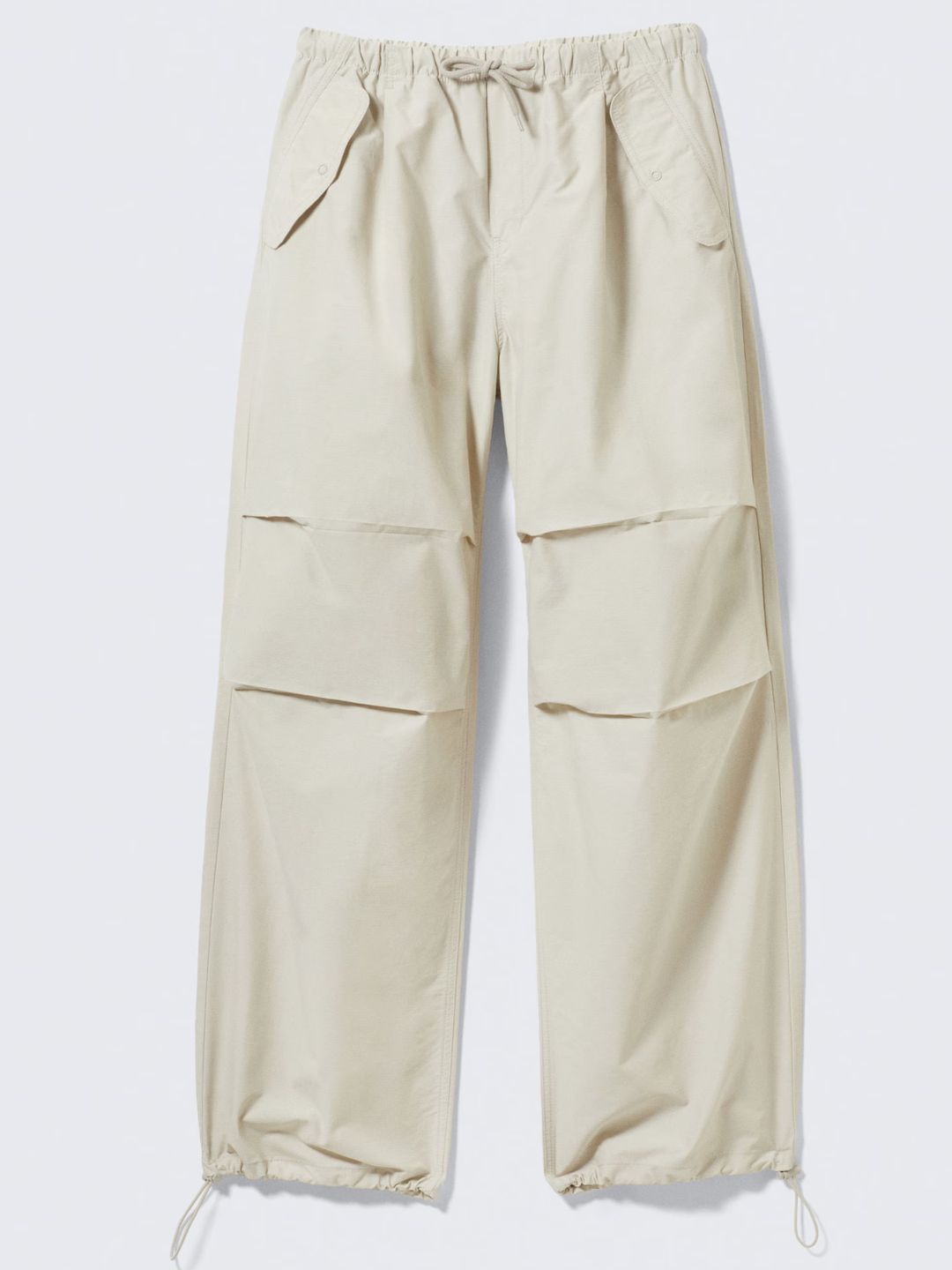 Beige pants with multiple pockets on a white background
