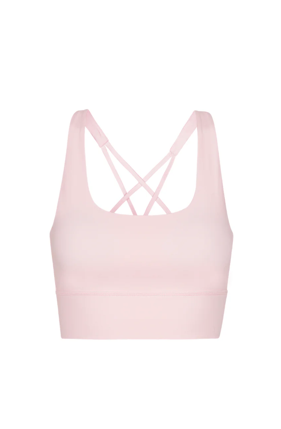 A woman wearing a pink sports bra and matching pants, posing with her hands raised and behind her head.