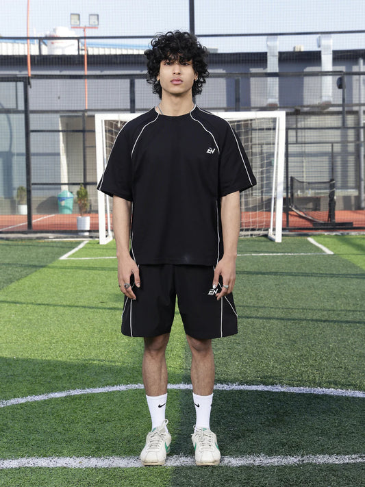Person wearing a black outfit on a sports field