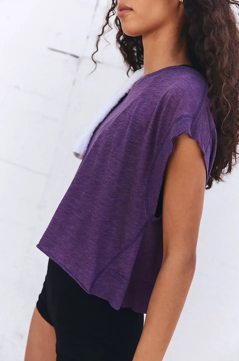 Person wearing a purple shirt against a white background
