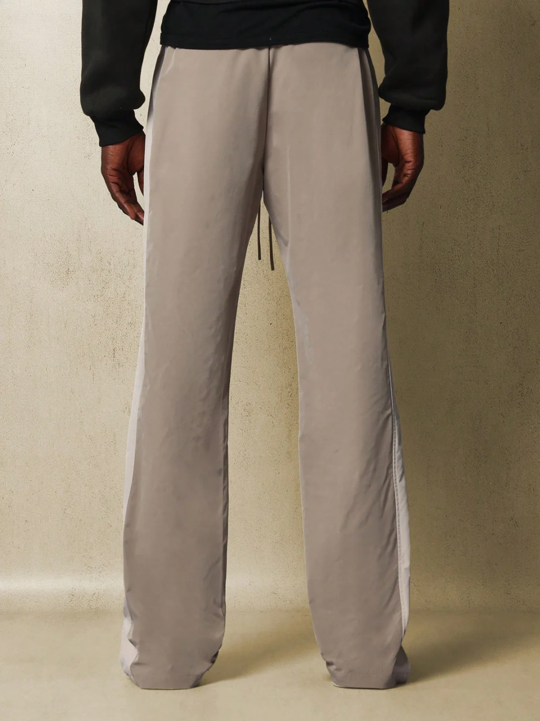 Core Pants, designed with simplicity and comfort in mind. The pants are gray, featuring a sleek and straight fit that accentuates a casual yet chic look.
