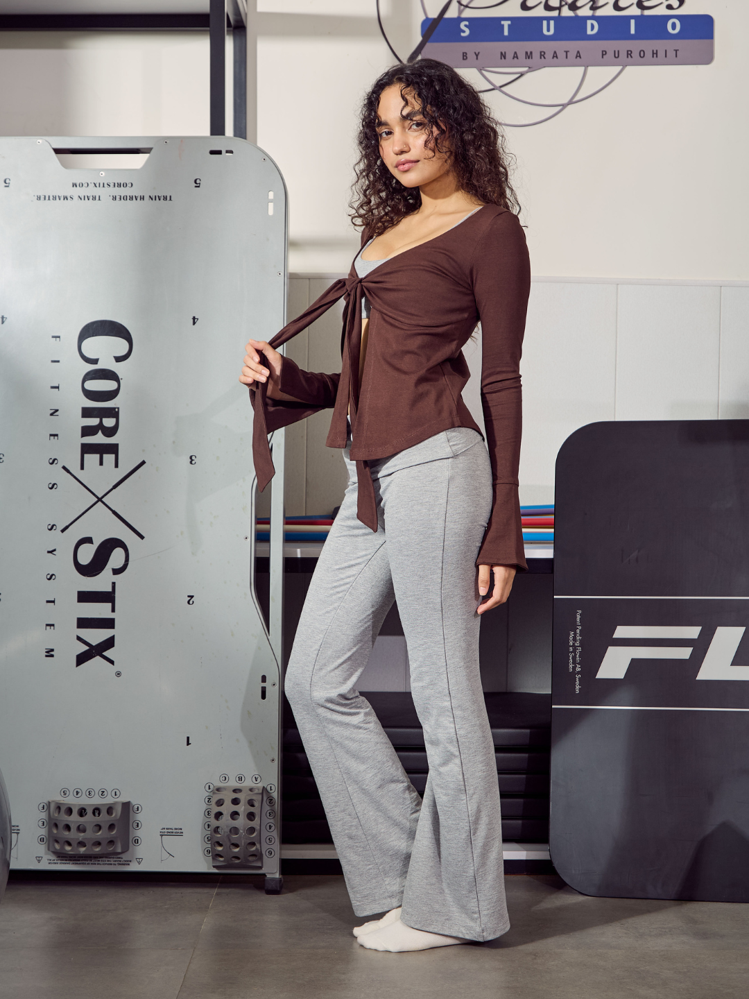 Woman standing next to a Core Stix product display in a studio setting