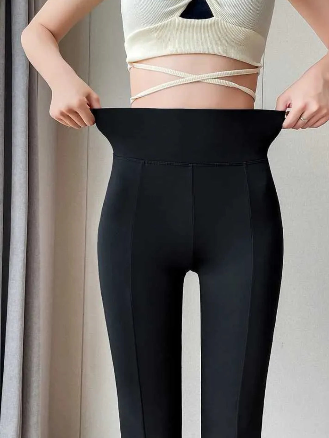 high-waist black yoga pants with a front slit, paired with white sneakers