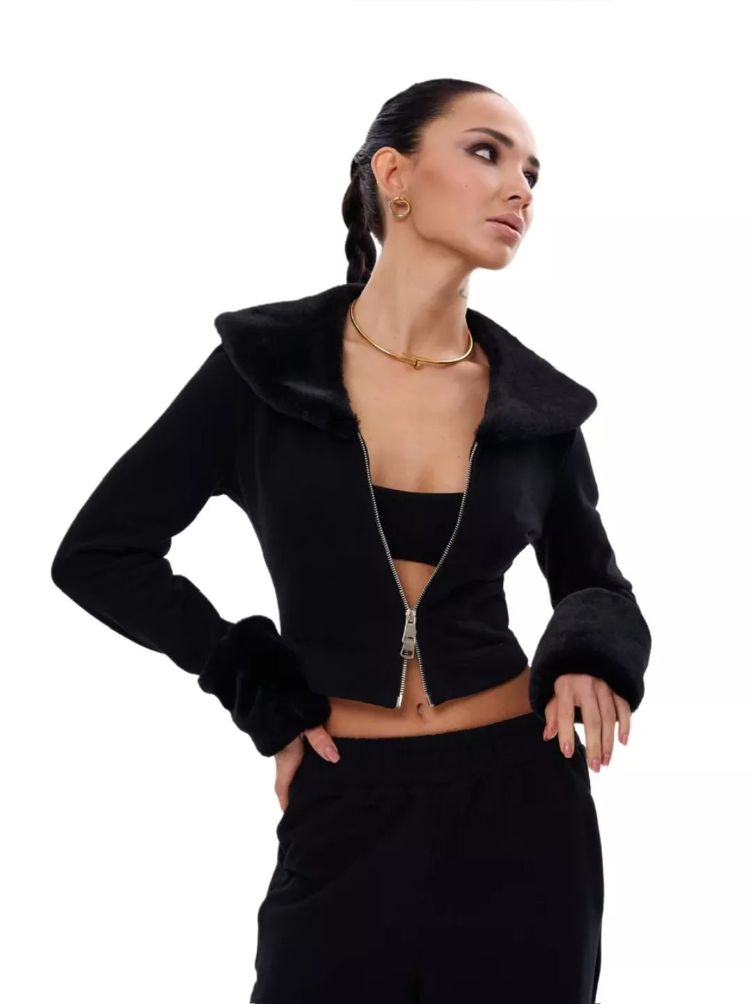 Woman wearing a black jacket and skirt on a white background