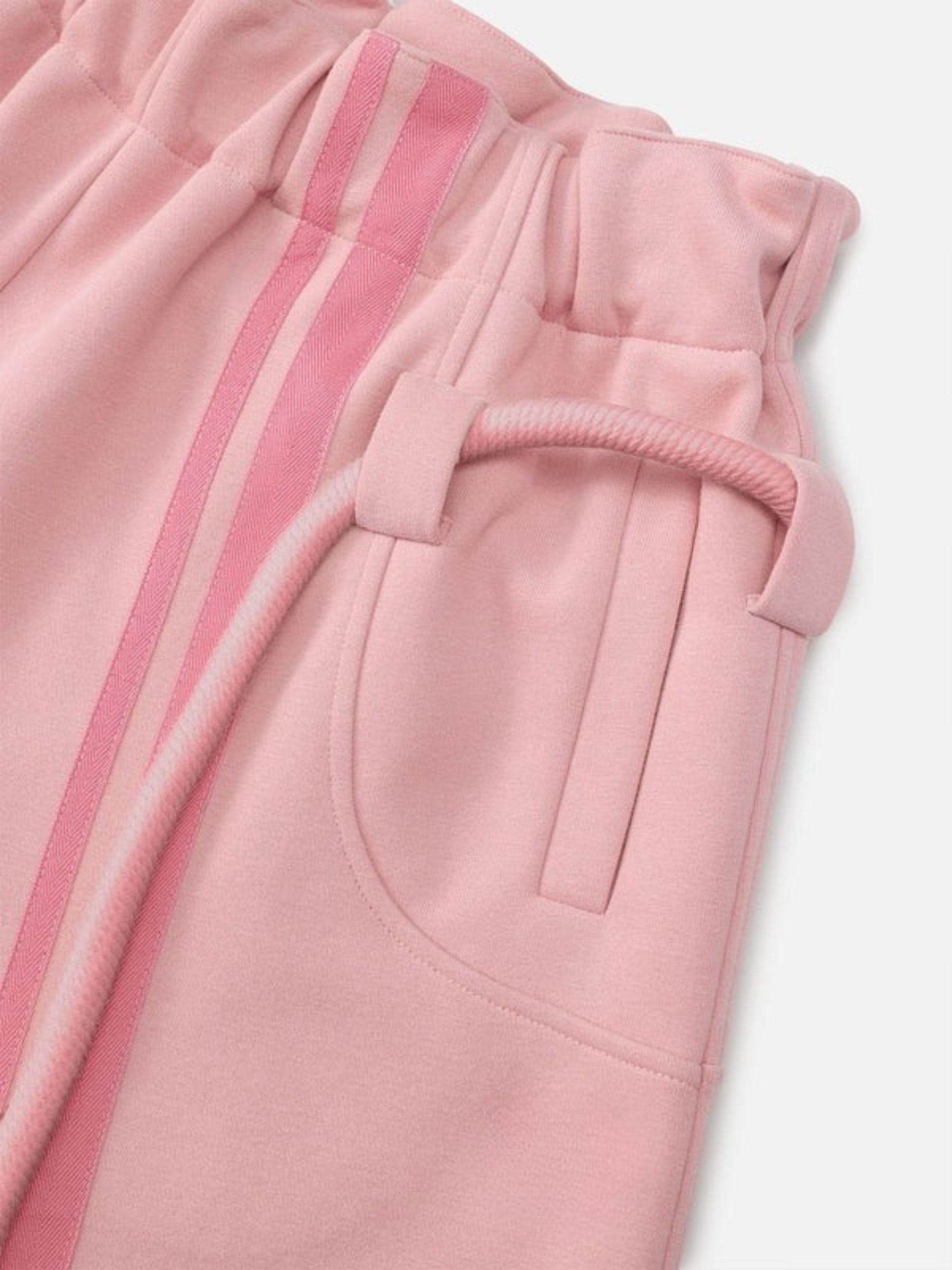 Close-up of pink pants with a drawstring on a white background
