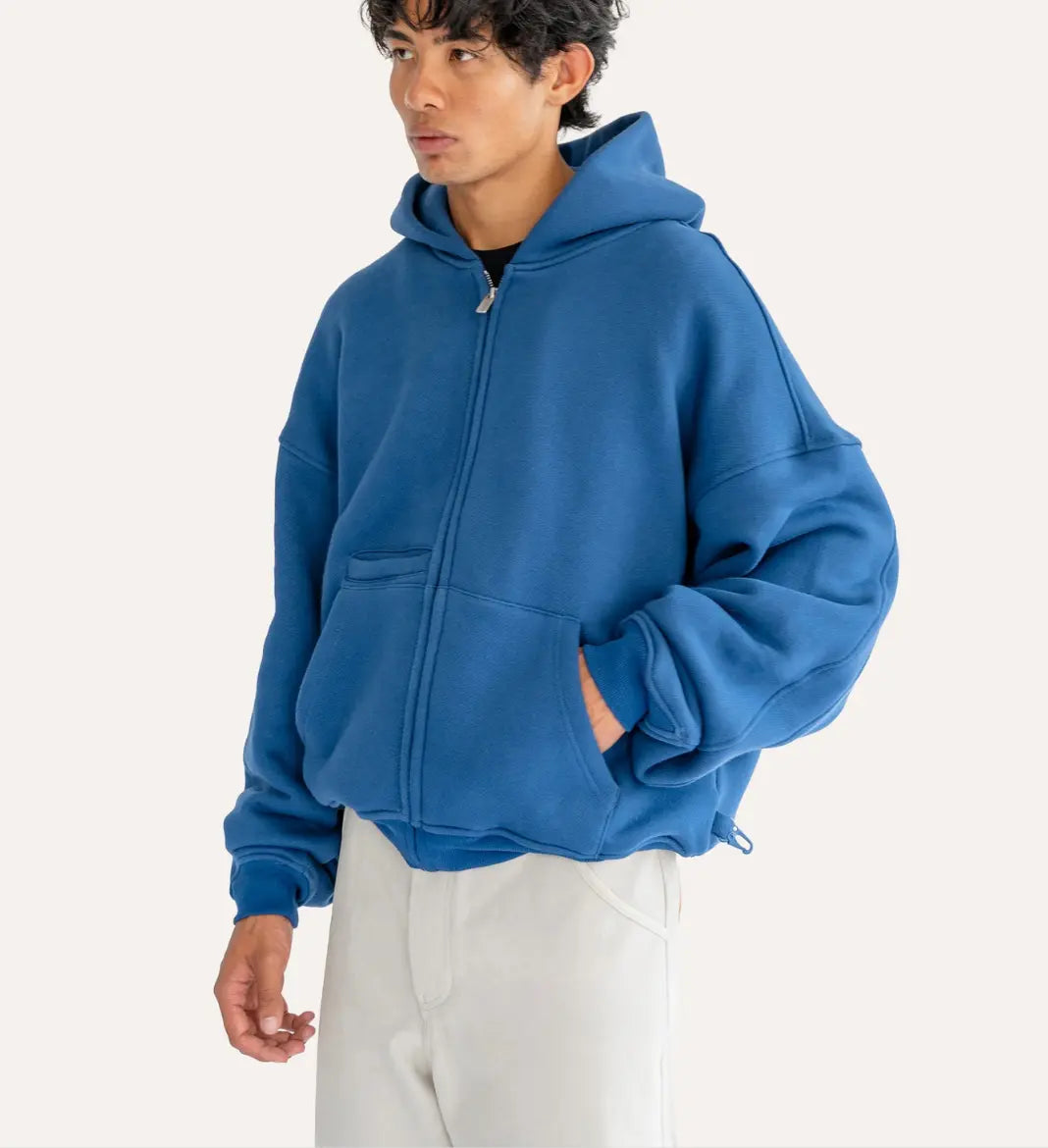 Person wearing a blue hoodie on a white background