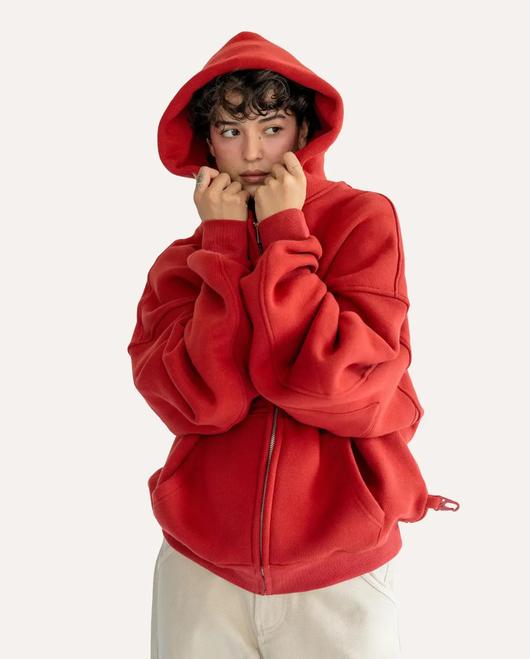 Person wearing a red hoodie on a white background