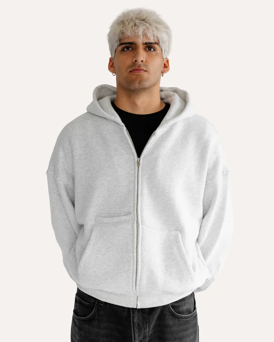 Person wearing a gray hoodie on a white background