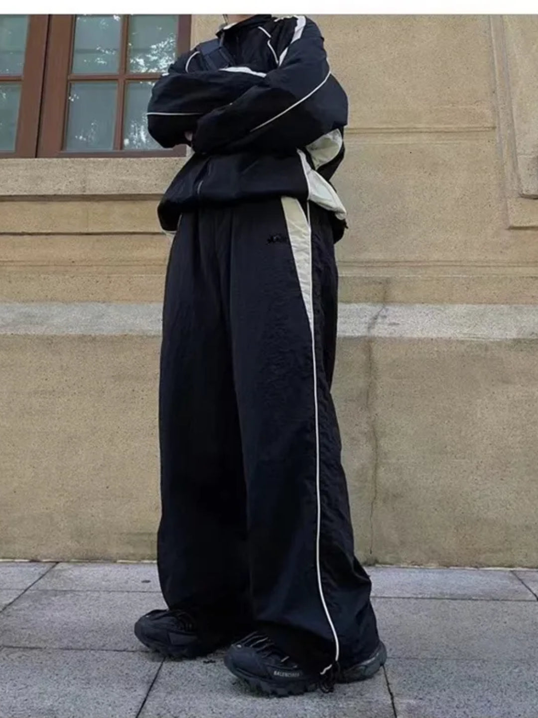 black trackpants with contrast white piping details