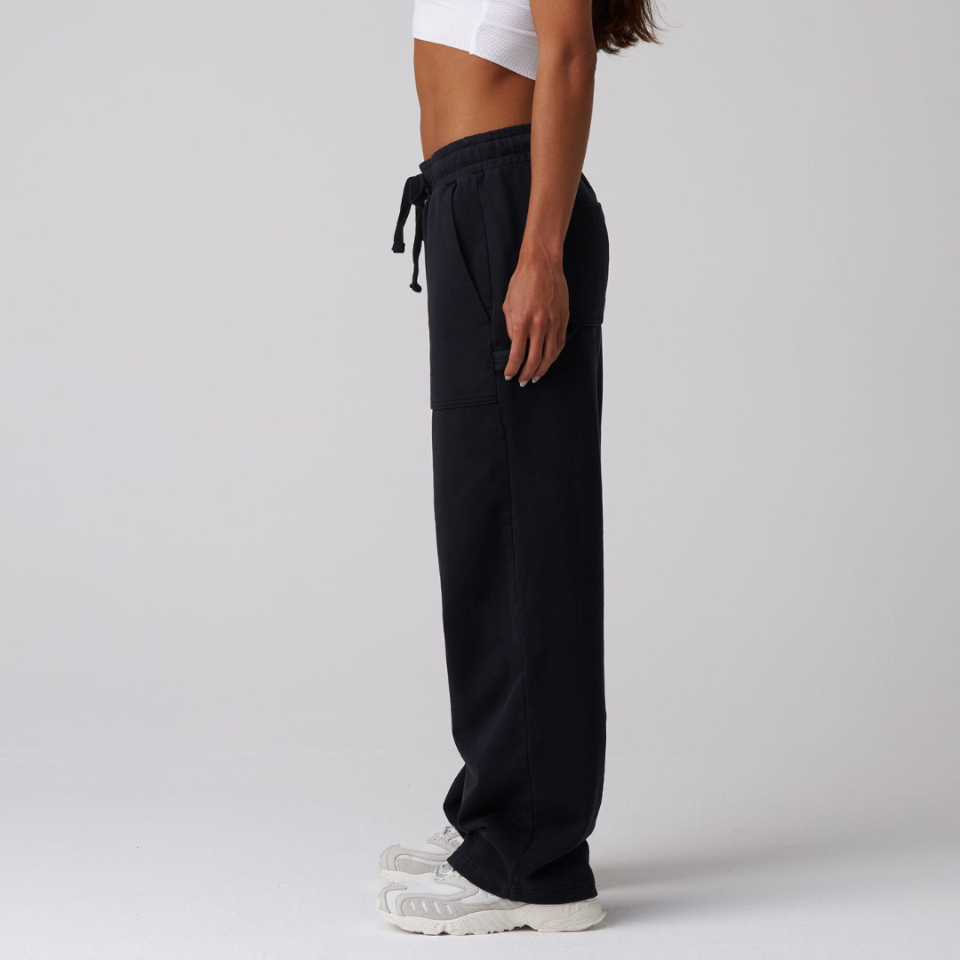black jersey carpenter sweatpants with an adjustable toggle hem at the ankle, featuring multiple pockets.