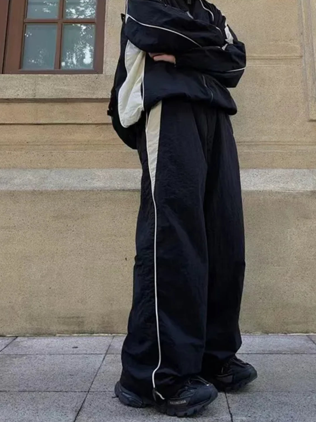 black trackpants with contrast white piping details